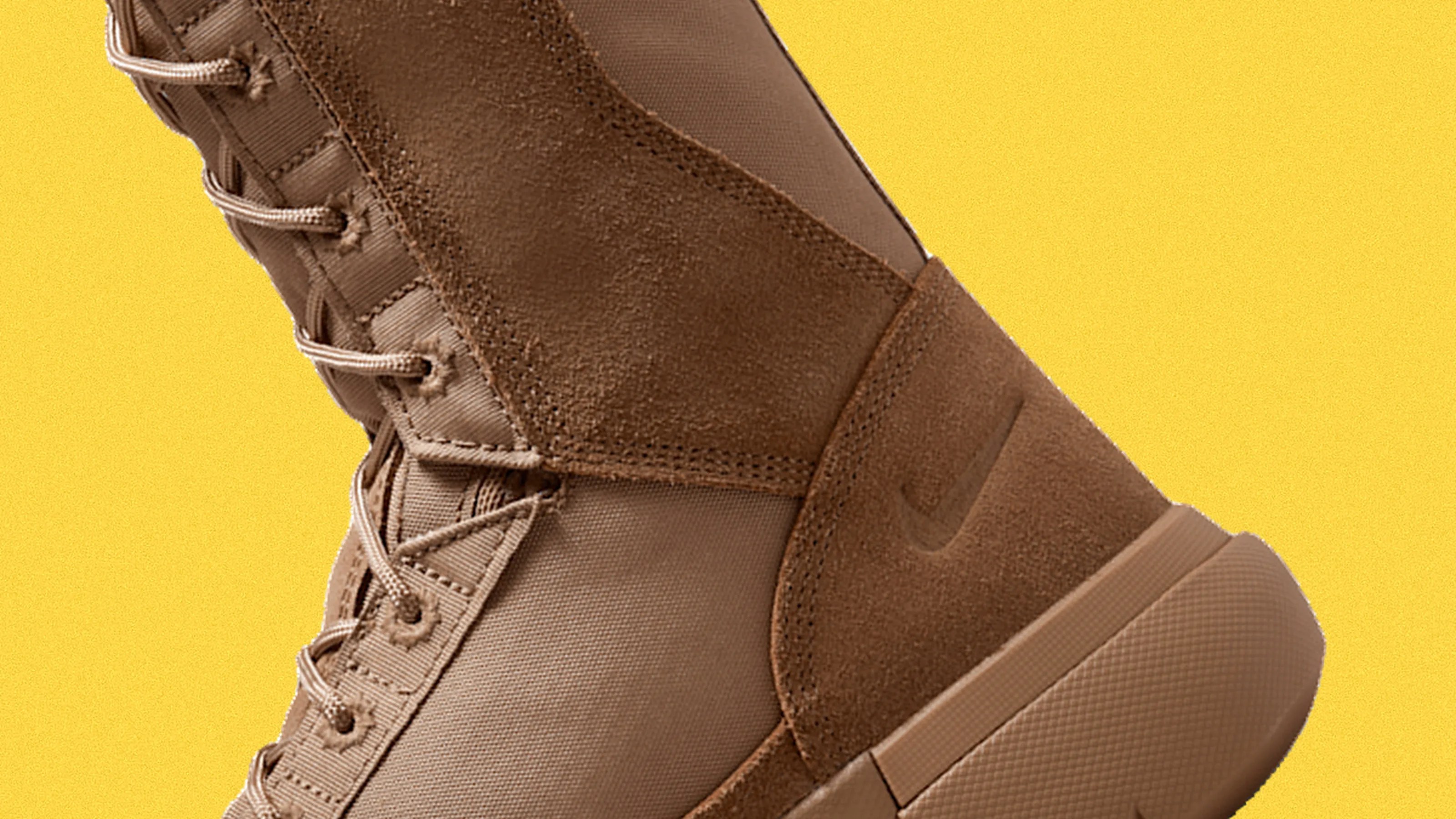 Tan high-top Nike boot with suede and fabric panels and a rubber sole on a yellow background.
