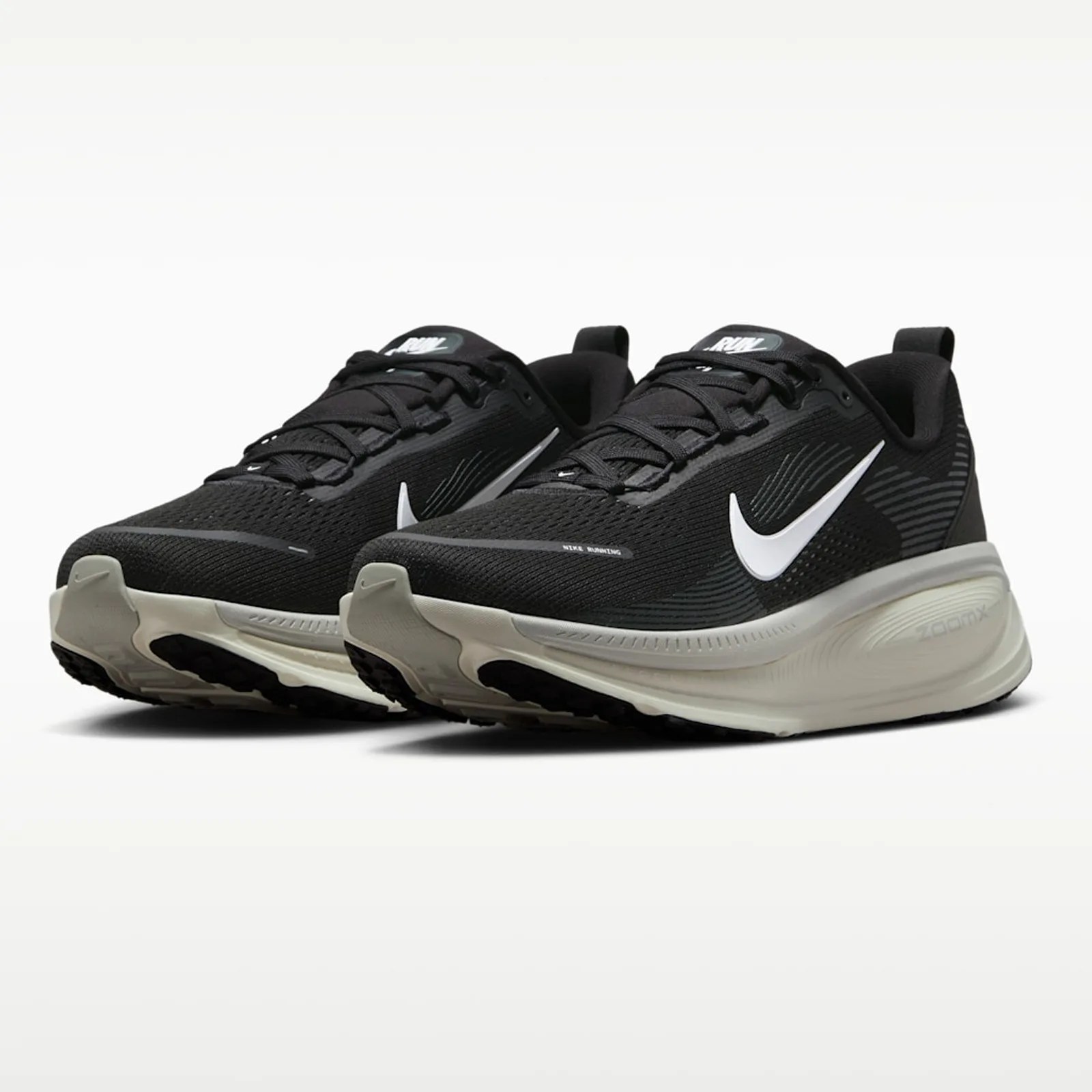 Pair of black Nike running shoes with white swoosh logos and thick white soles.