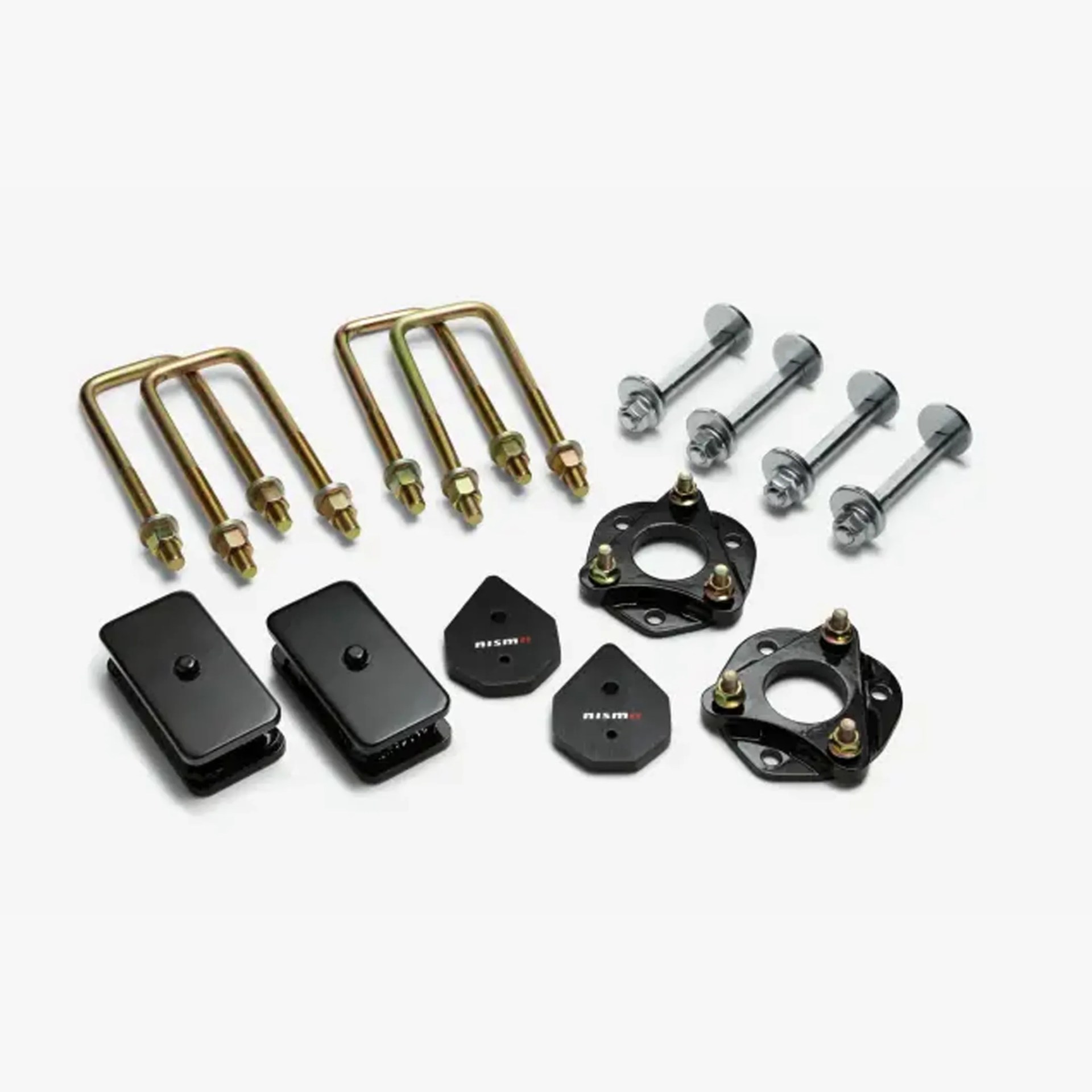 Set of automotive suspension lift components including U-bolts, bolts, black metal brackets, and spacers with "nismo" branding.