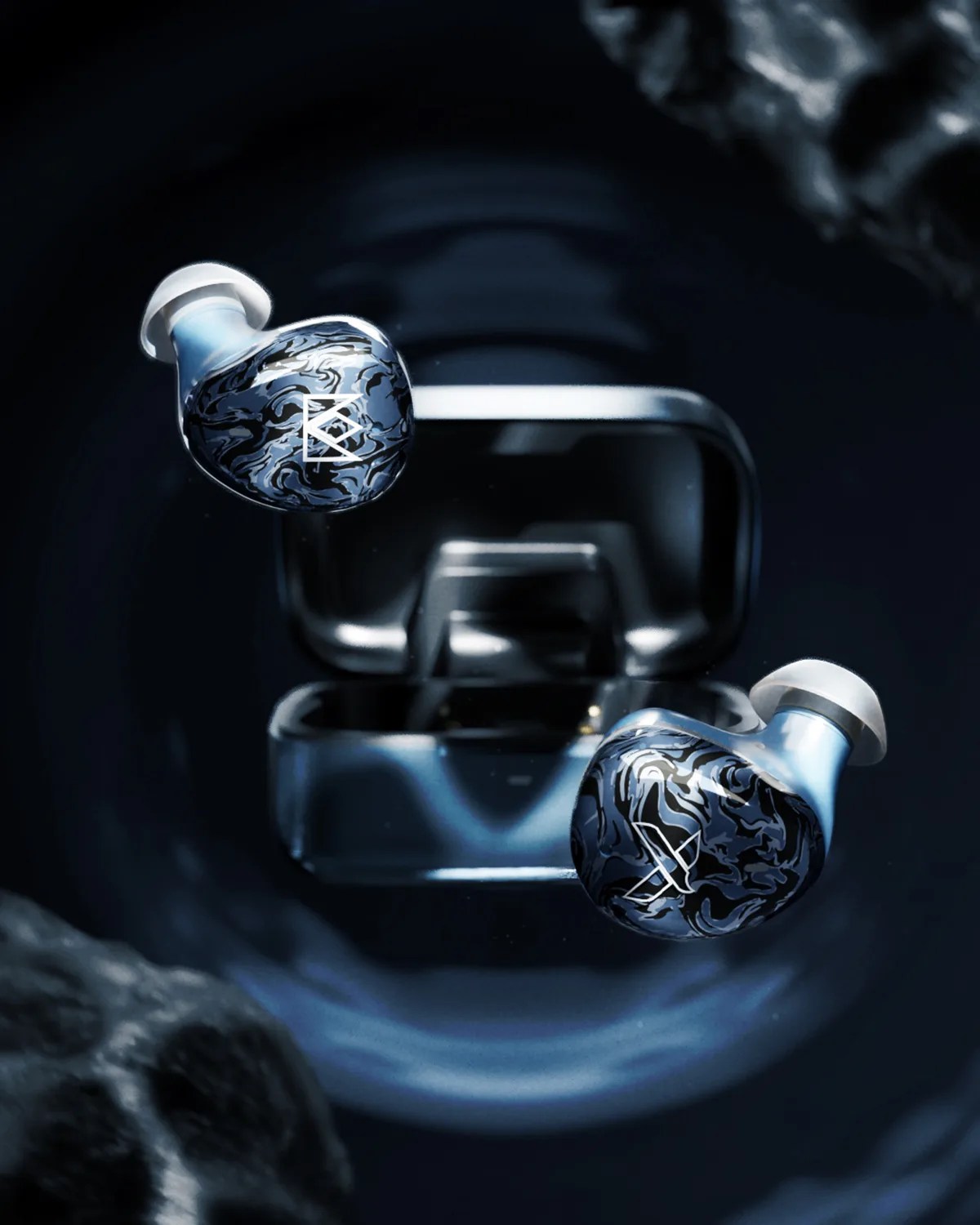 Pair of black and blue marbled wireless earbuds with white logos floating above an open black charging case.