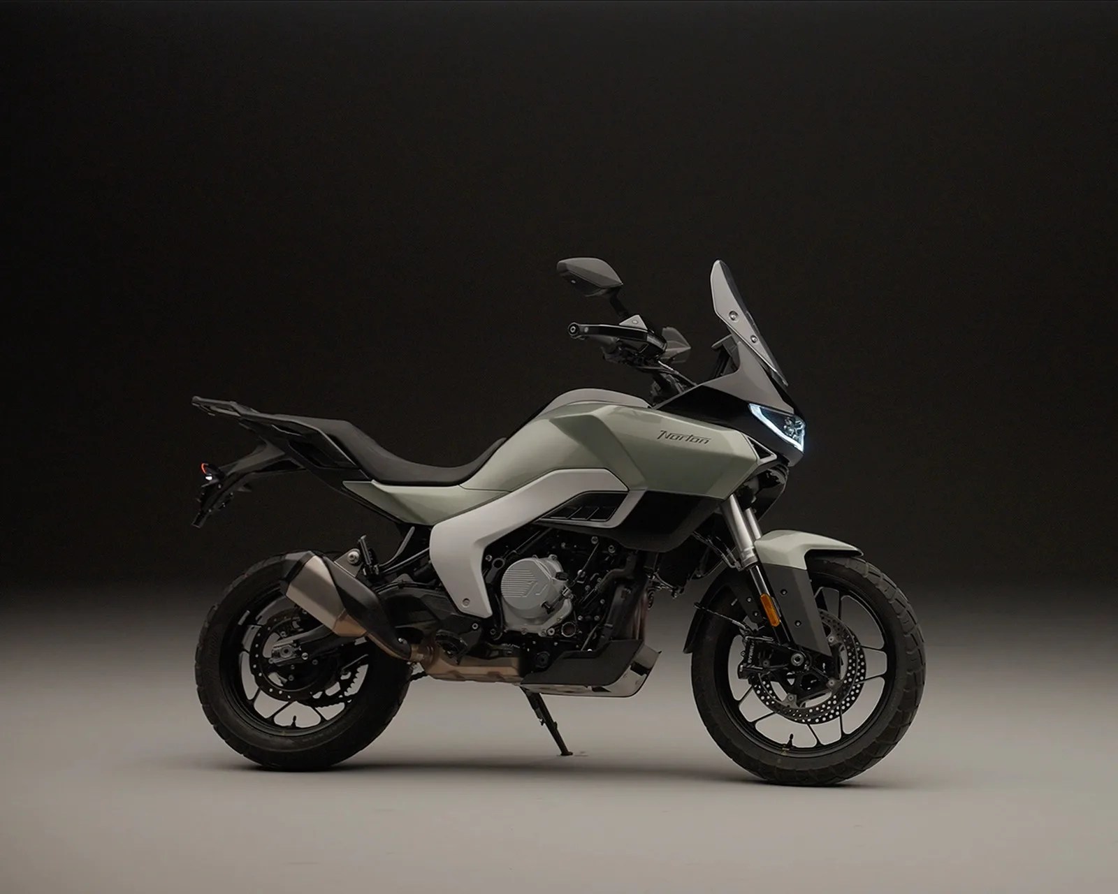 Matte light gray Norton motorcycle with black accents and LED headlight on a neutral background.