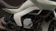 Close-up of a white and black Norton motorcycle engine and seat area.
