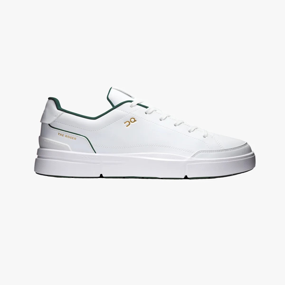 White low-top sneaker with green trim, gold logo, and thick white sole.