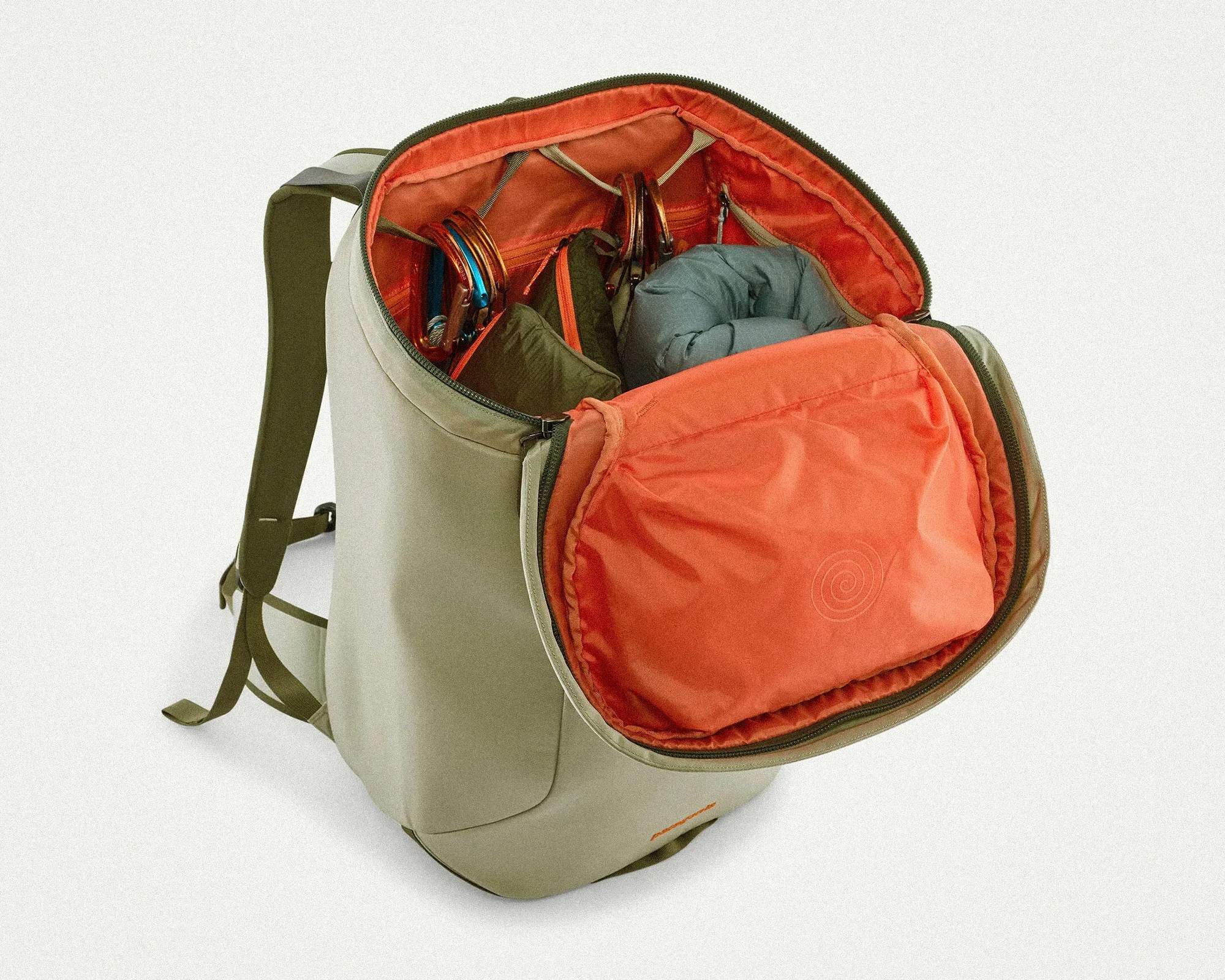 Olive green backpack with orange interior and multiple compartments holding climbing gear and a rolled jacket.