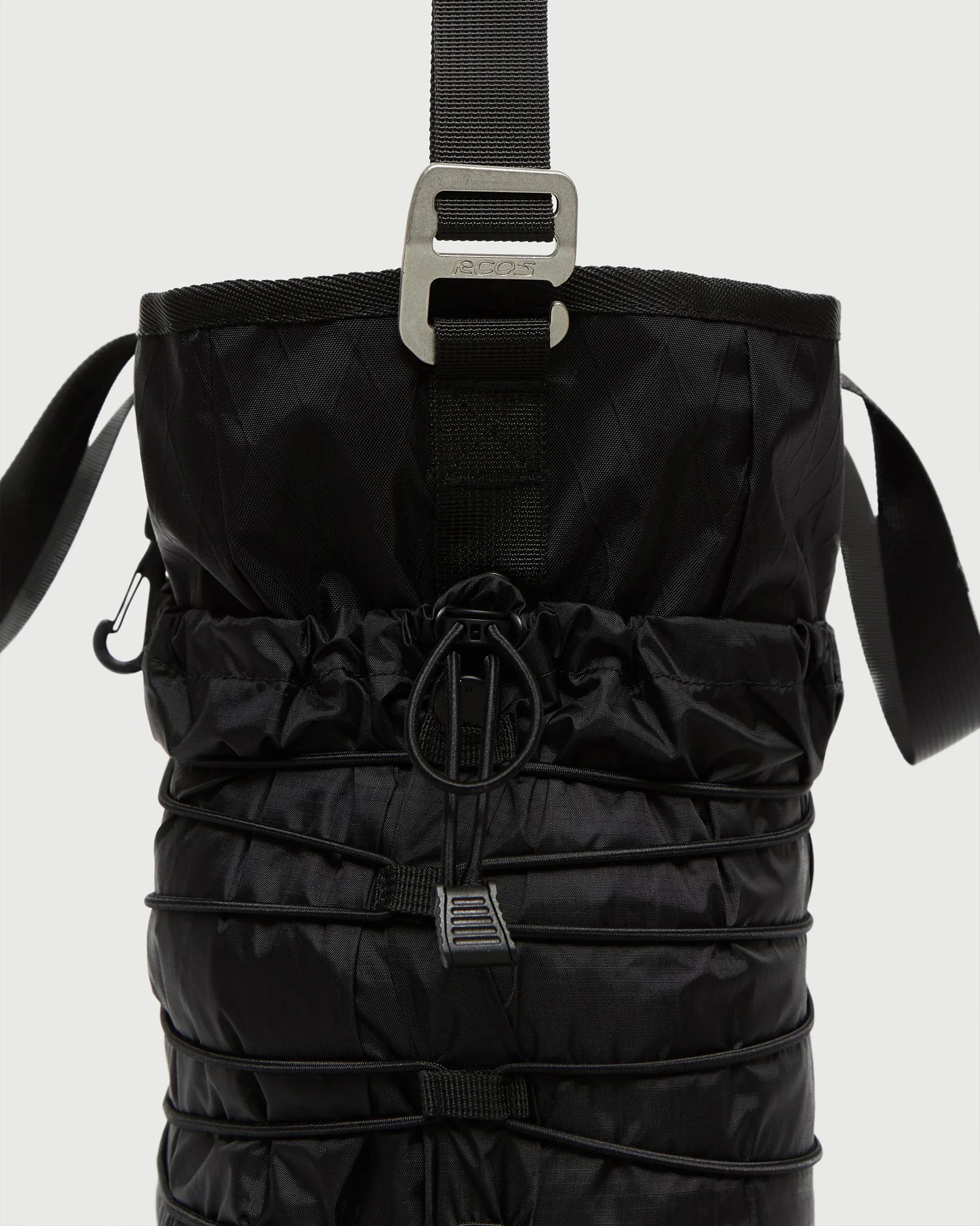 Black nylon bag with drawstring closure and metal buckle strap.