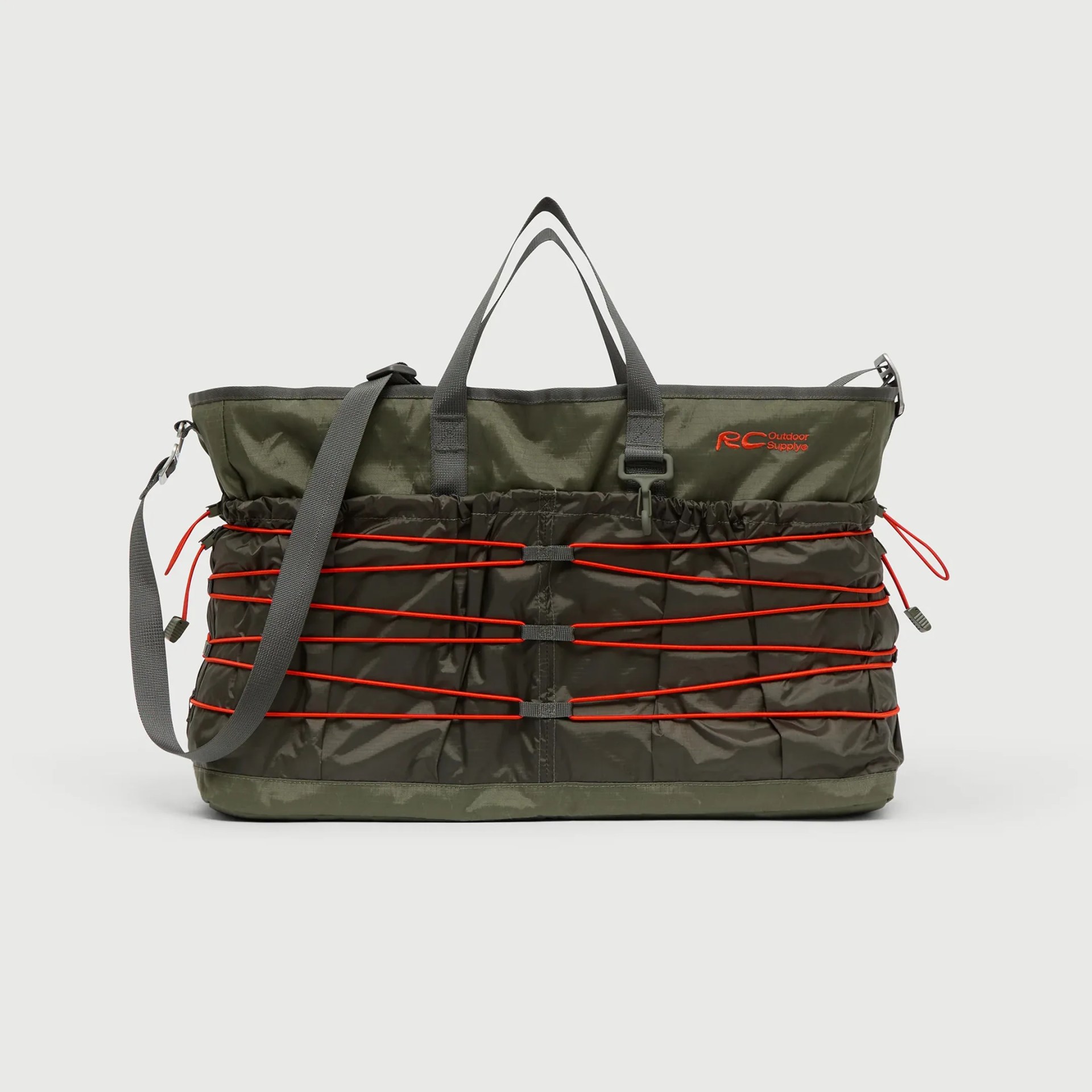 Olive green and dark green tote bag with red bungee cords and gray straps, featuring "RC Outdoor Supply" logo.