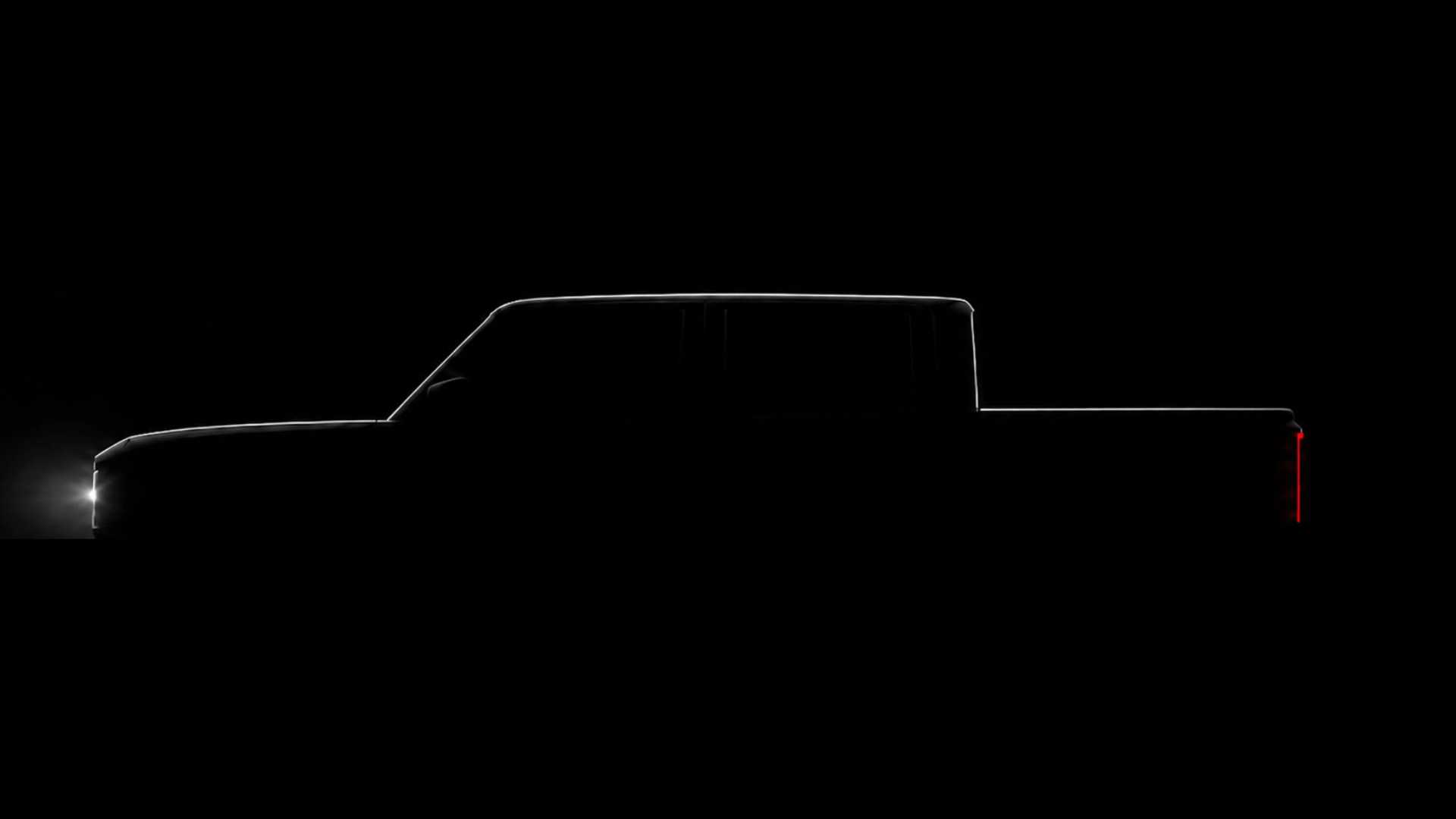 Silhouette of a pickup truck with illuminated front headlight and vertical red rear taillight on a black background.