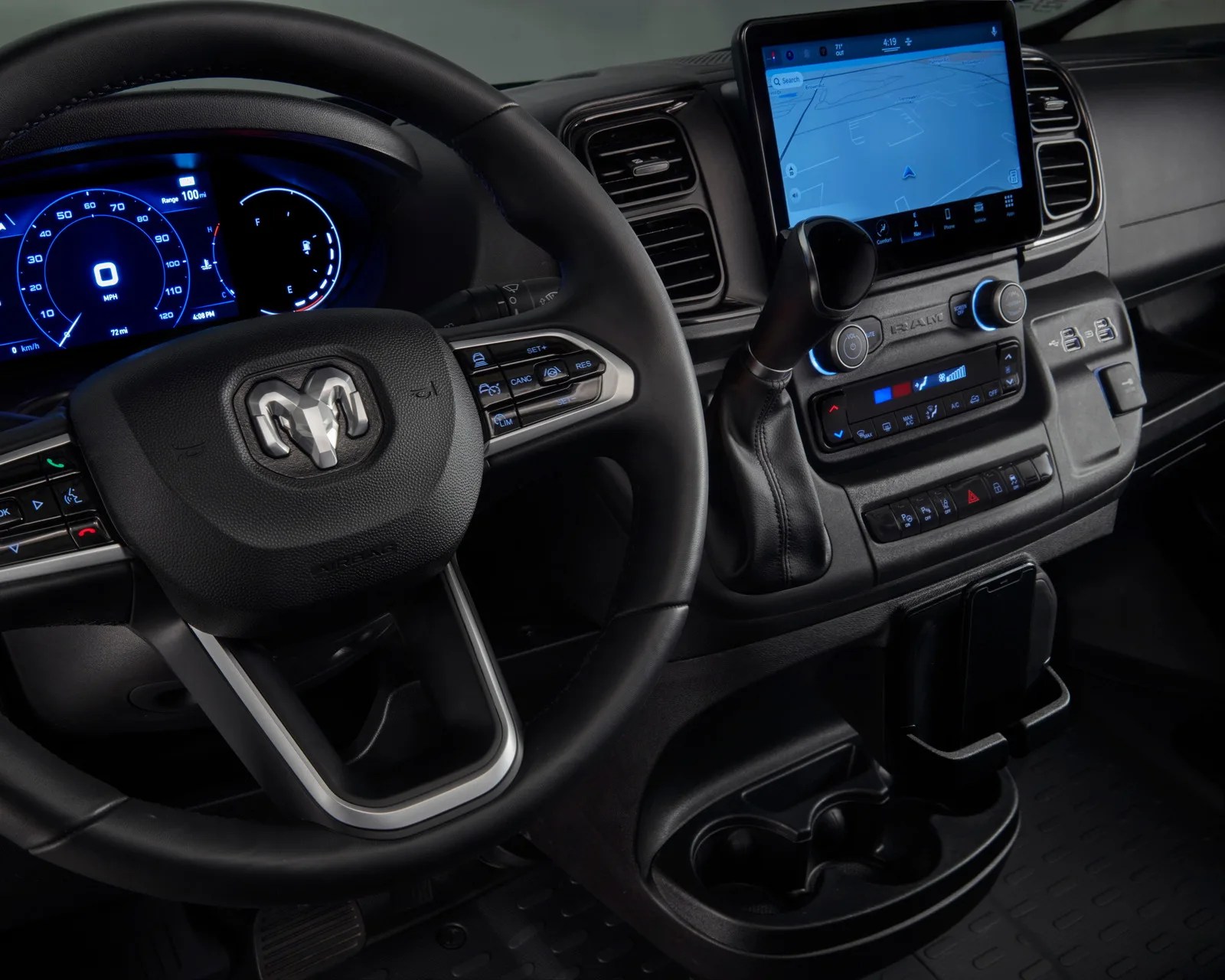 Black steering wheel with RAM logo, digital dashboard, touchscreen navigation, and gear shift in a vehicle interior.