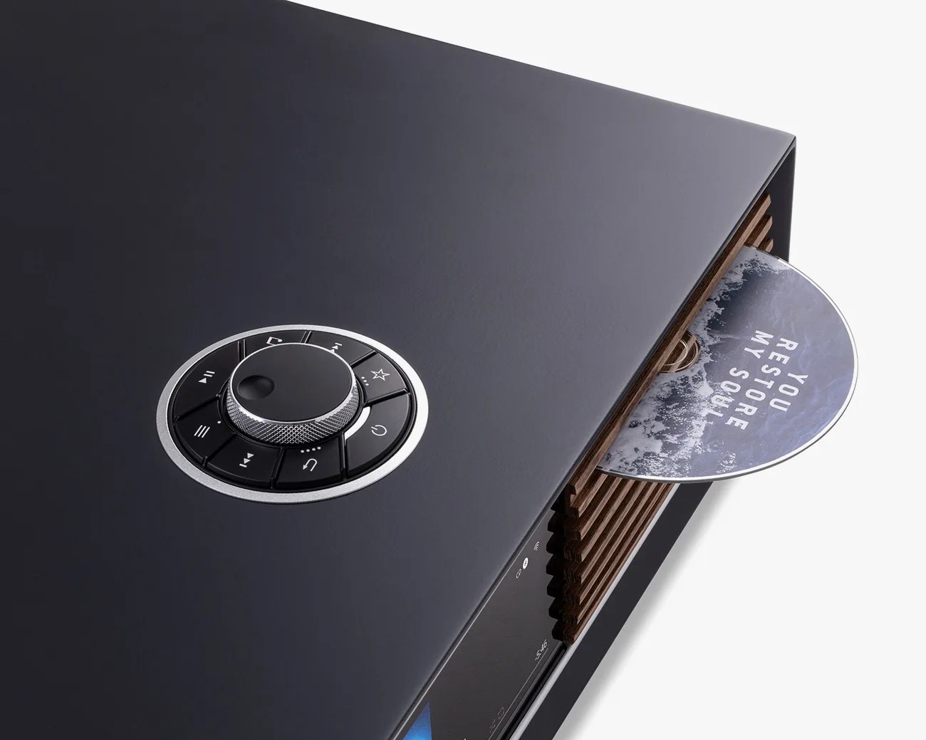 Black audio system with a circular control dial and a CD partially inserted with the text "YOU RESTORE MY SOUL.