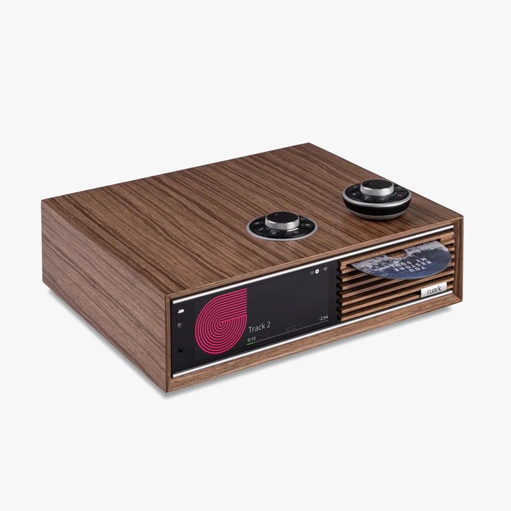 Wood-finished audio player with digital display, two rotary dials on top, and a CD partially inserted in the front slot.