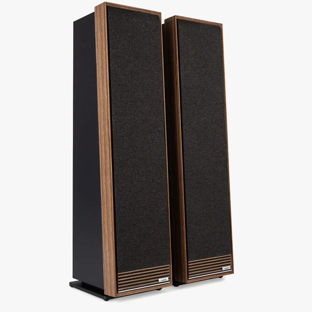 Pair of tall, rectangular floor-standing speakers with black fabric fronts and wood veneer side panels.