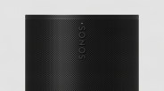 Close-up of a black Sonos speaker grille with perforated holes and a small white indicator light.