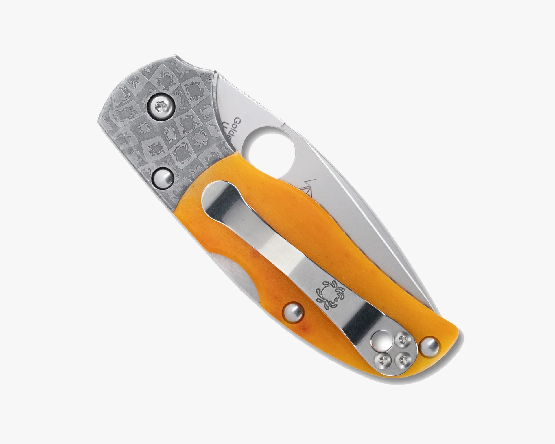 Folding pocket knife with a yellow handle, patterned metal bolster, and a metal clip with a spider logo.