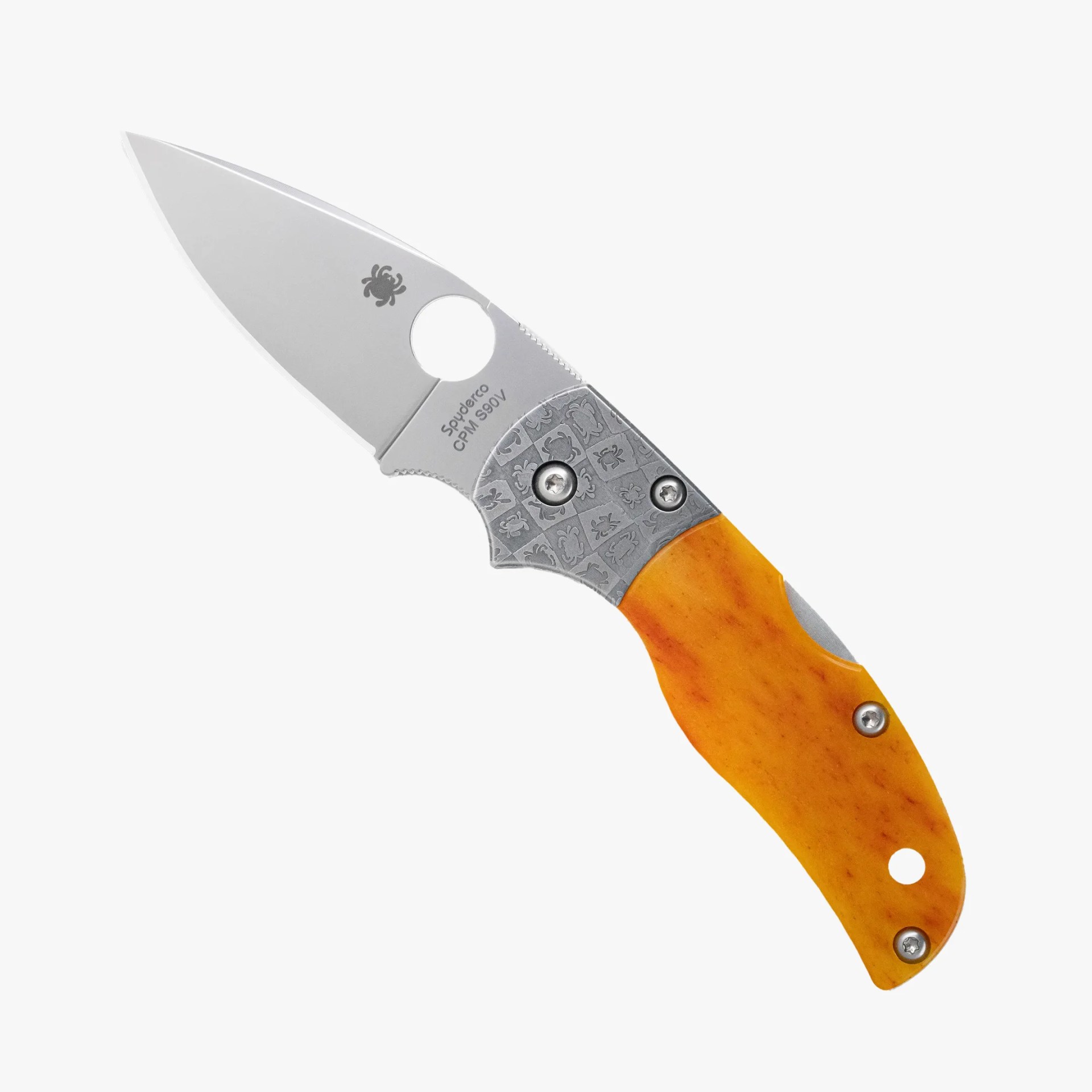 Folding knife with a silver CPM S90V steel blade and an orange handle with patterned metal bolsters.