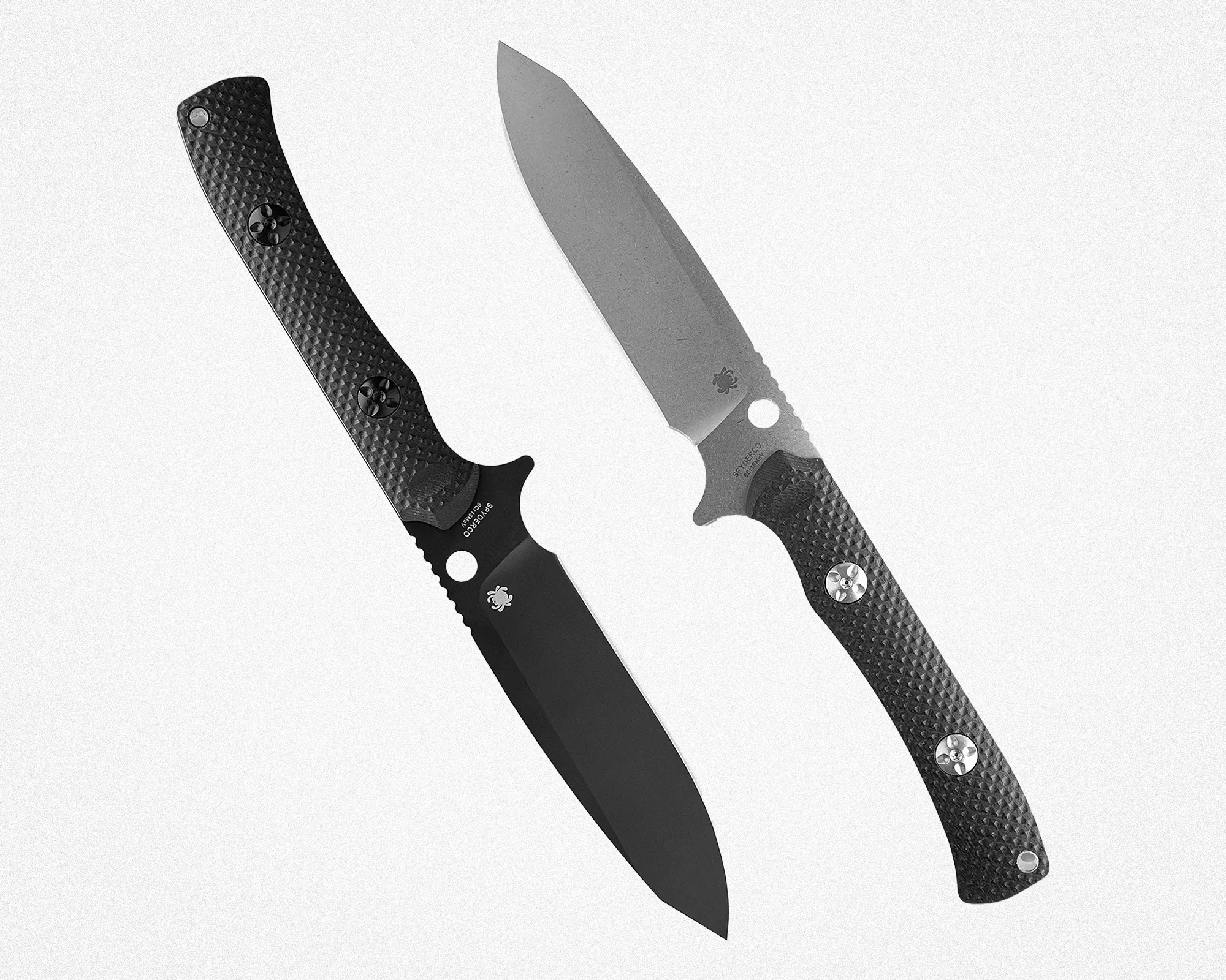 Two Spyderco folding knives with textured black handles, one with a black blade and the other with a silver blade, on a white background.