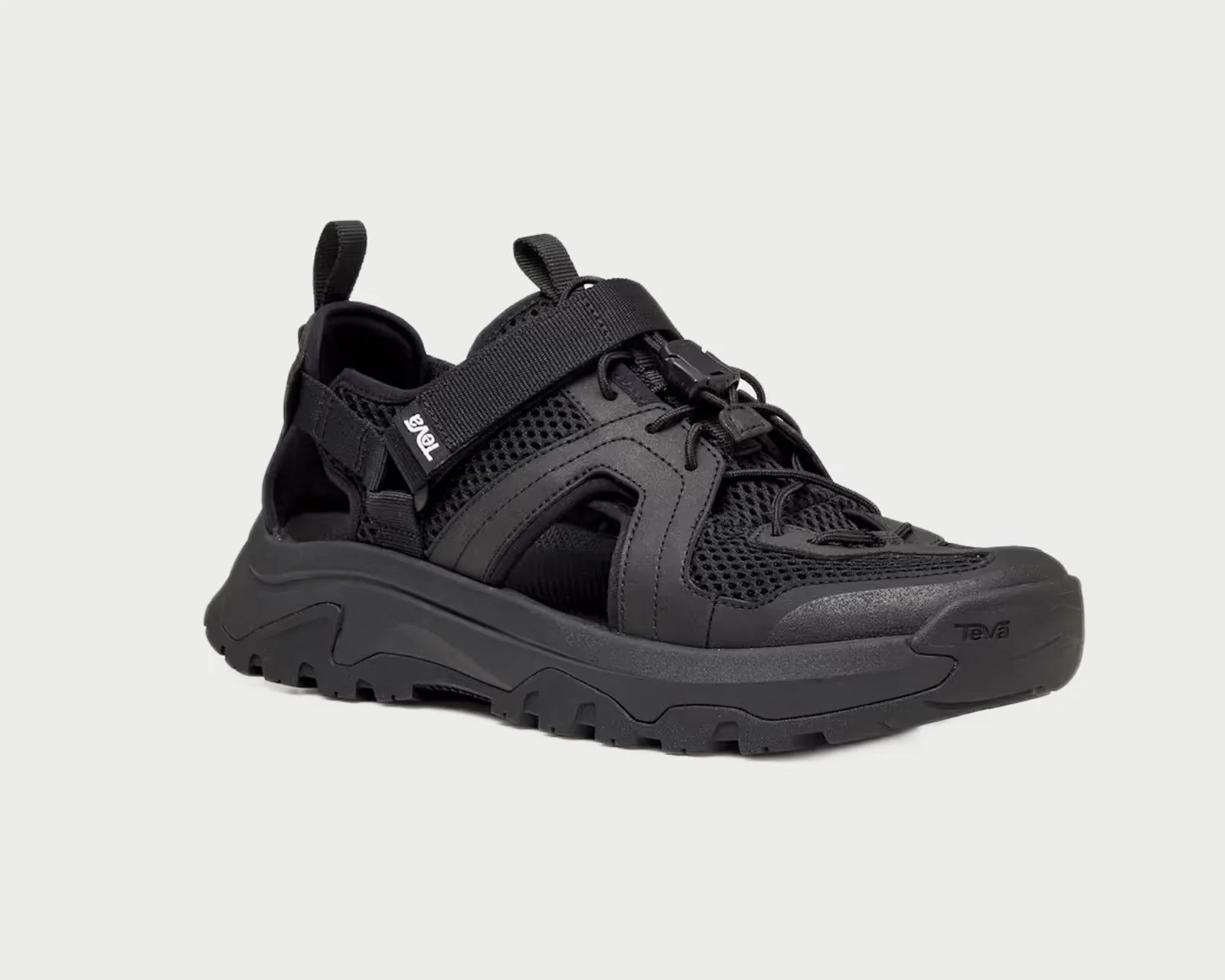 Black Teva sneaker sandal with mesh upper, adjustable strap, and rugged sole.