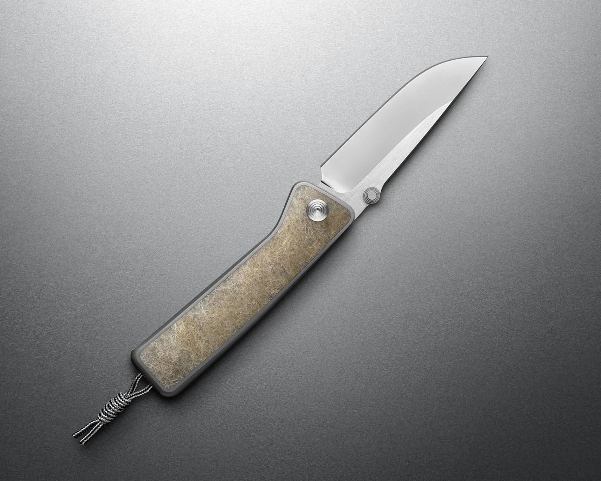 Folding knife with a polished steel blade and a textured beige handle on a gray surface.