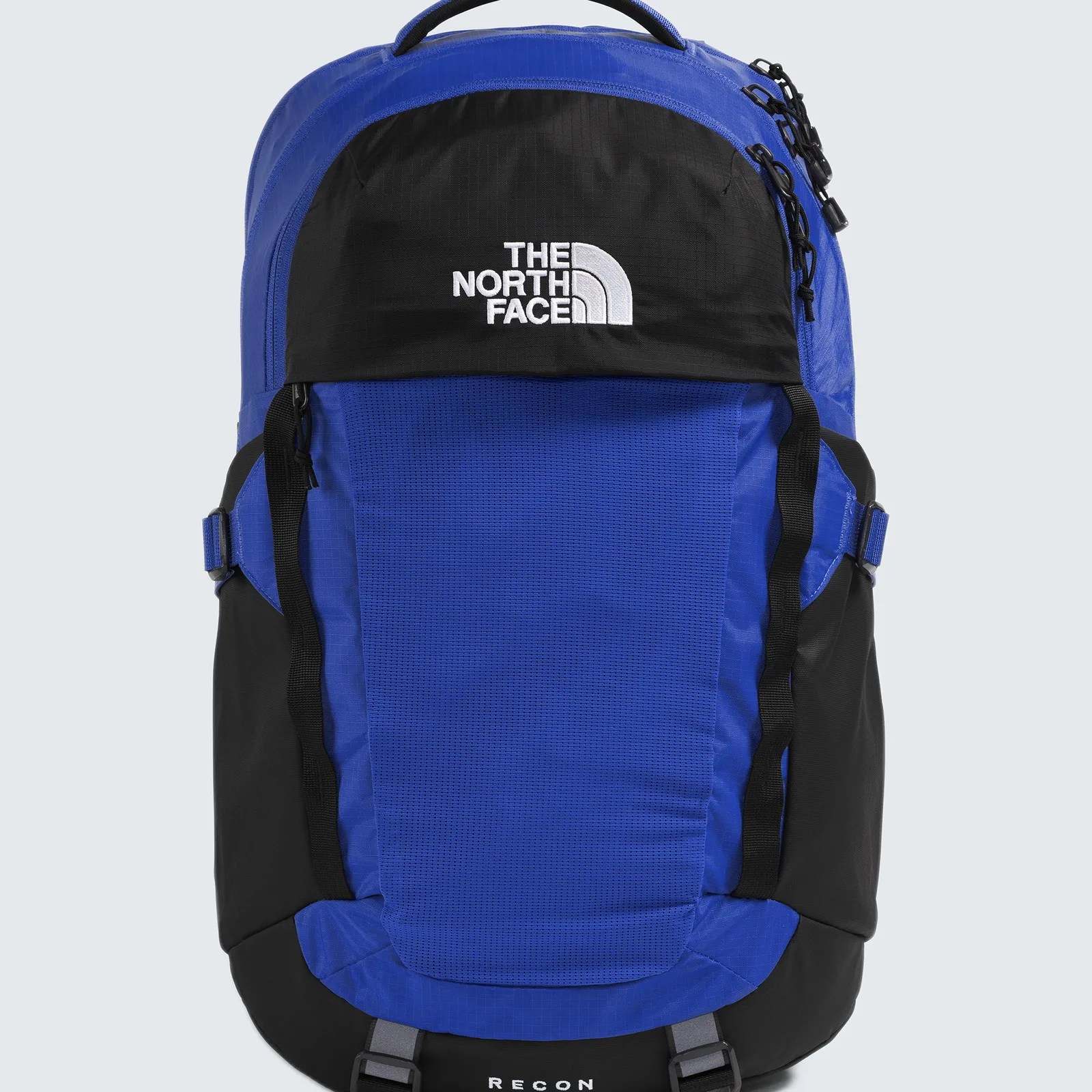 Blue and black The North Face Recon backpack with white logo and front straps.