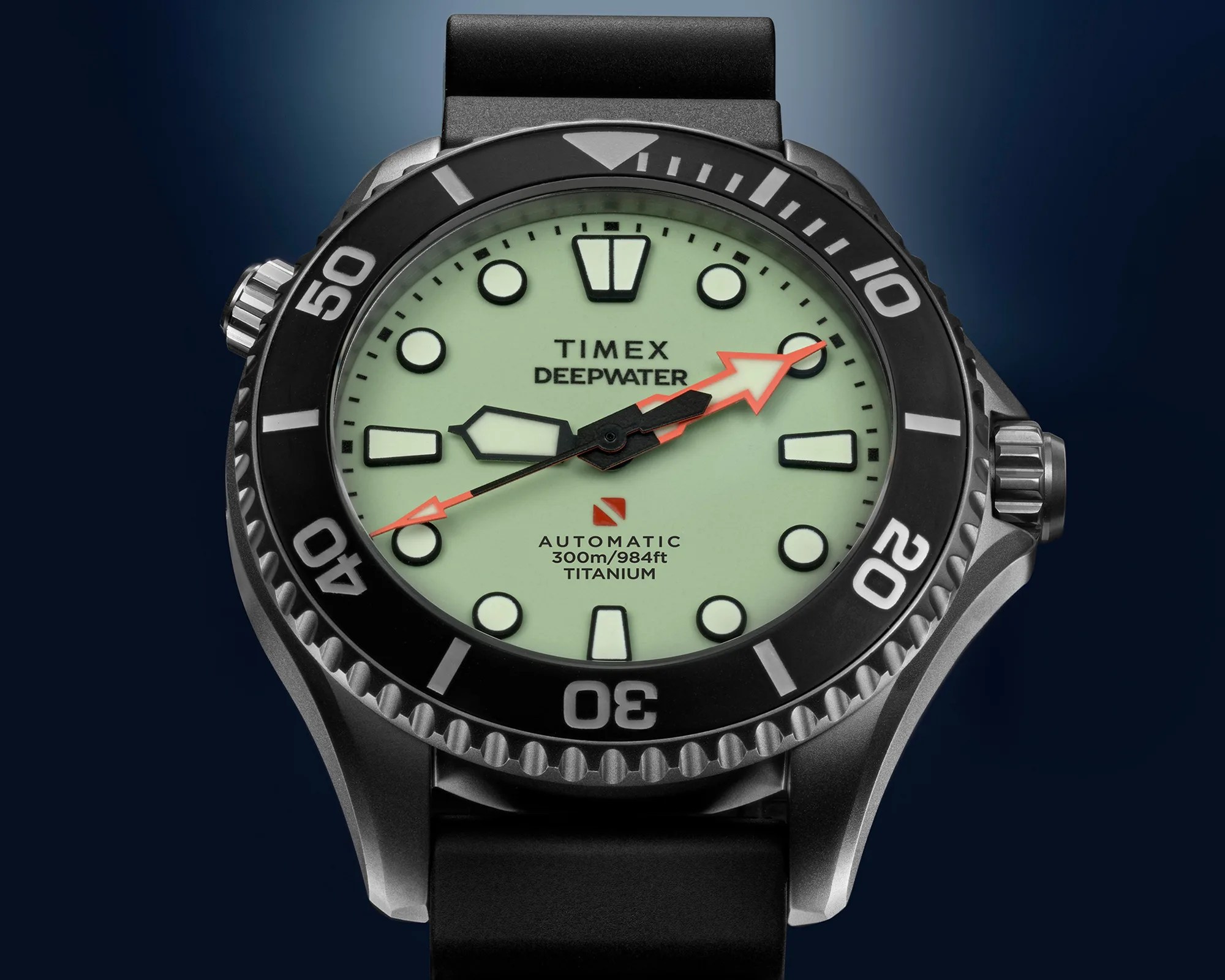 Close-up of a Timex Deepwater automatic dive watch with a black bezel, pale green dial, and black rubber strap.