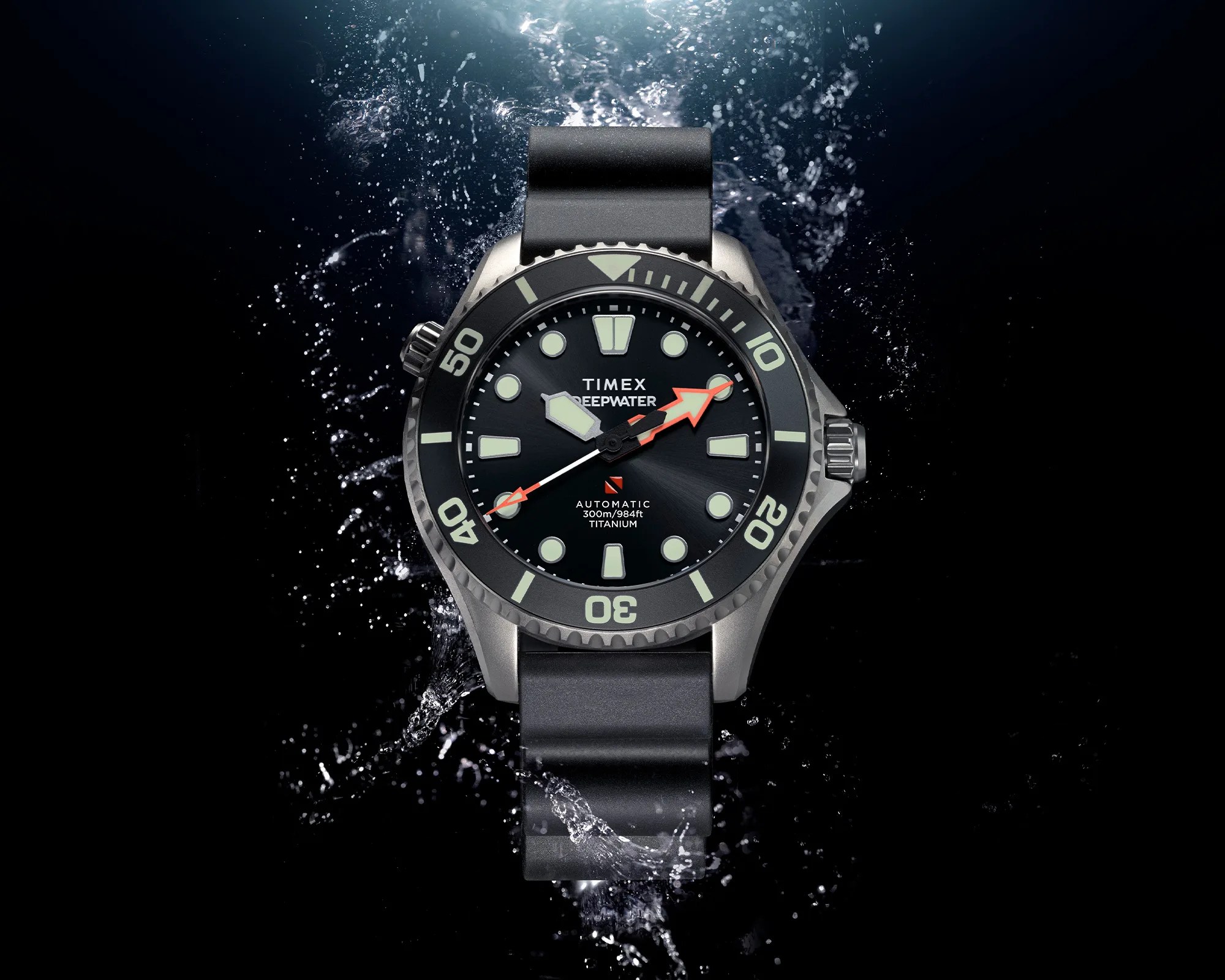 Titanium Timex Deepwater automatic dive watch with black dial, luminous markers, and black strap underwater with water splashes.
