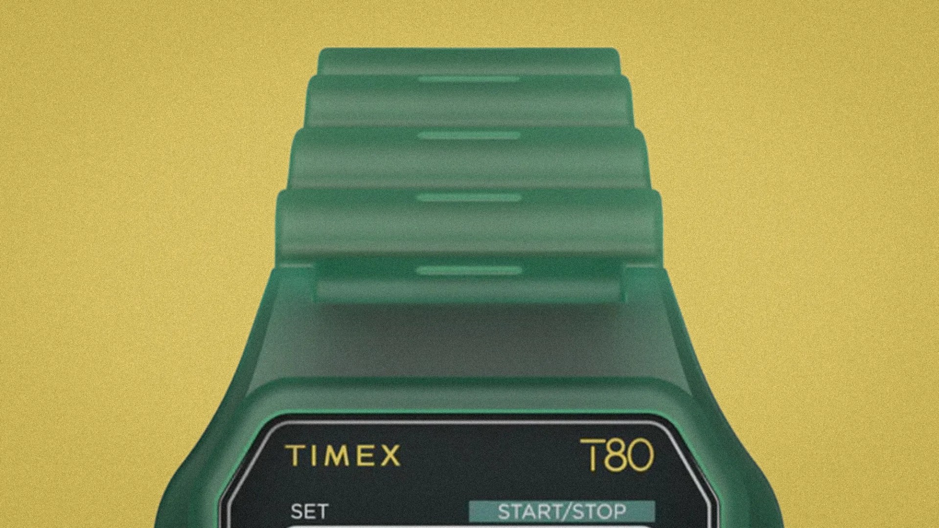 Green Timex T80 digital watch with segmented strap on a yellow background.