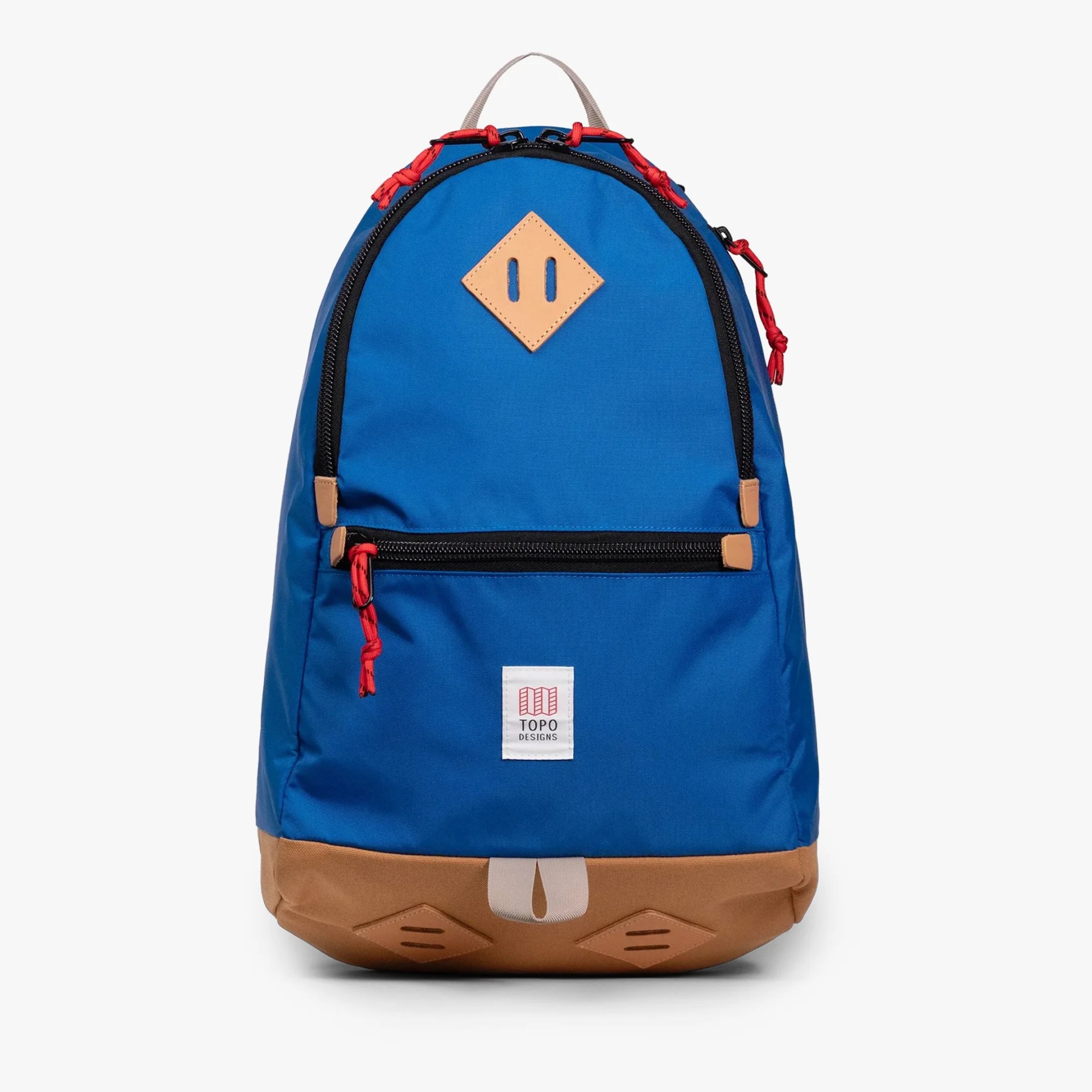 Blue and tan backpack with red zipper pulls and a white Topo Designs logo patch on the front.
