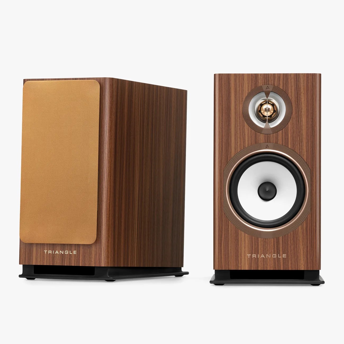 Pair of bookshelf speakers with walnut wood finish, one with a gold fabric grille and the other showing white and gold speaker drivers.