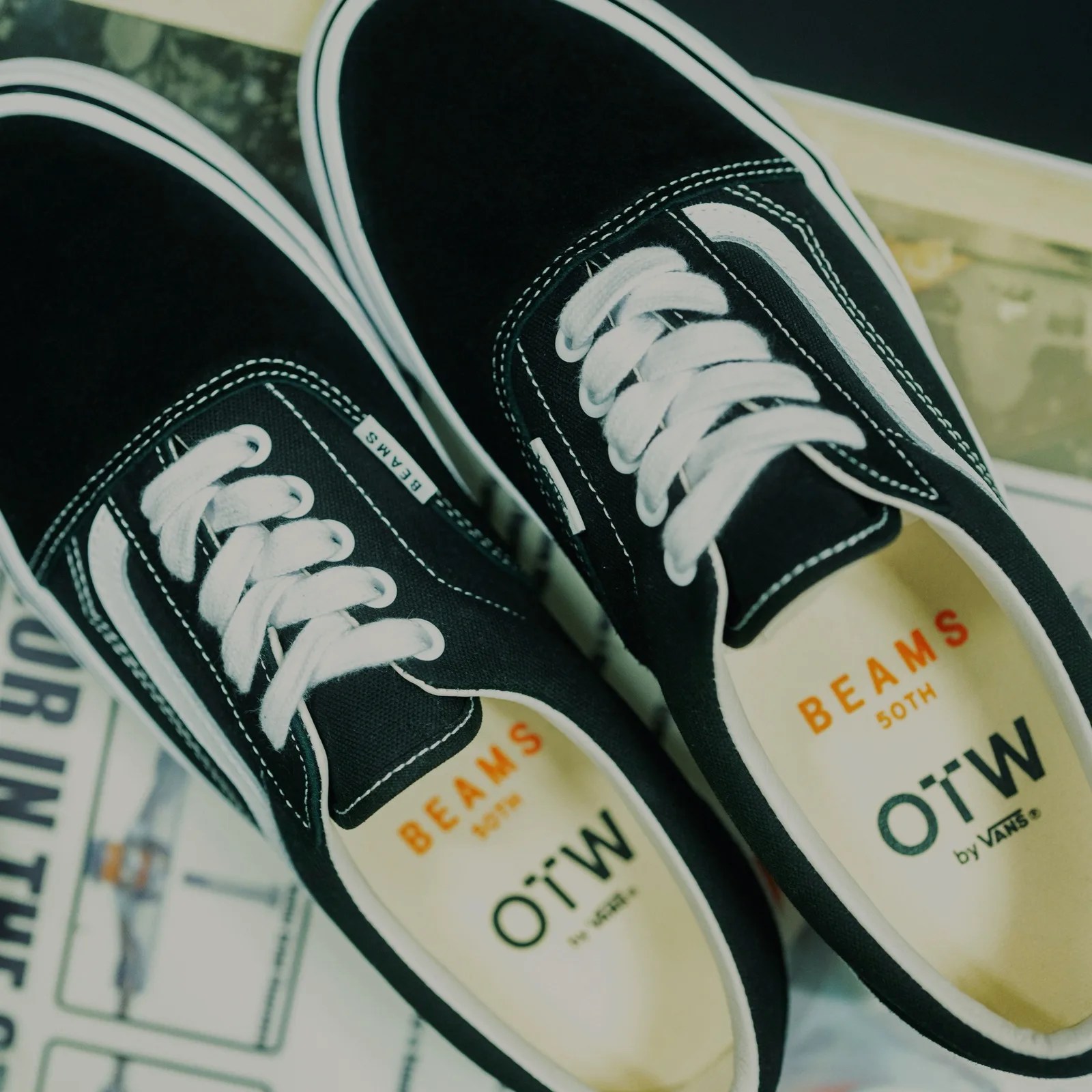 Pair of black Vans OTW sneakers with white laces and white side stripe, labeled "BEAMS 50TH" inside.