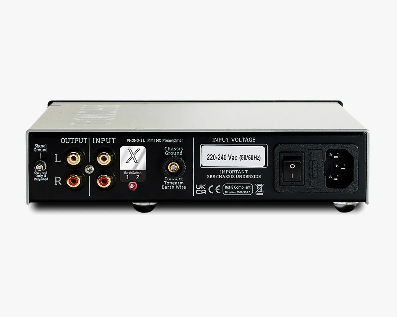 Rear panel of a silver audio preamplifier with RCA input/output ports, grounding terminals, voltage label, and power switch.