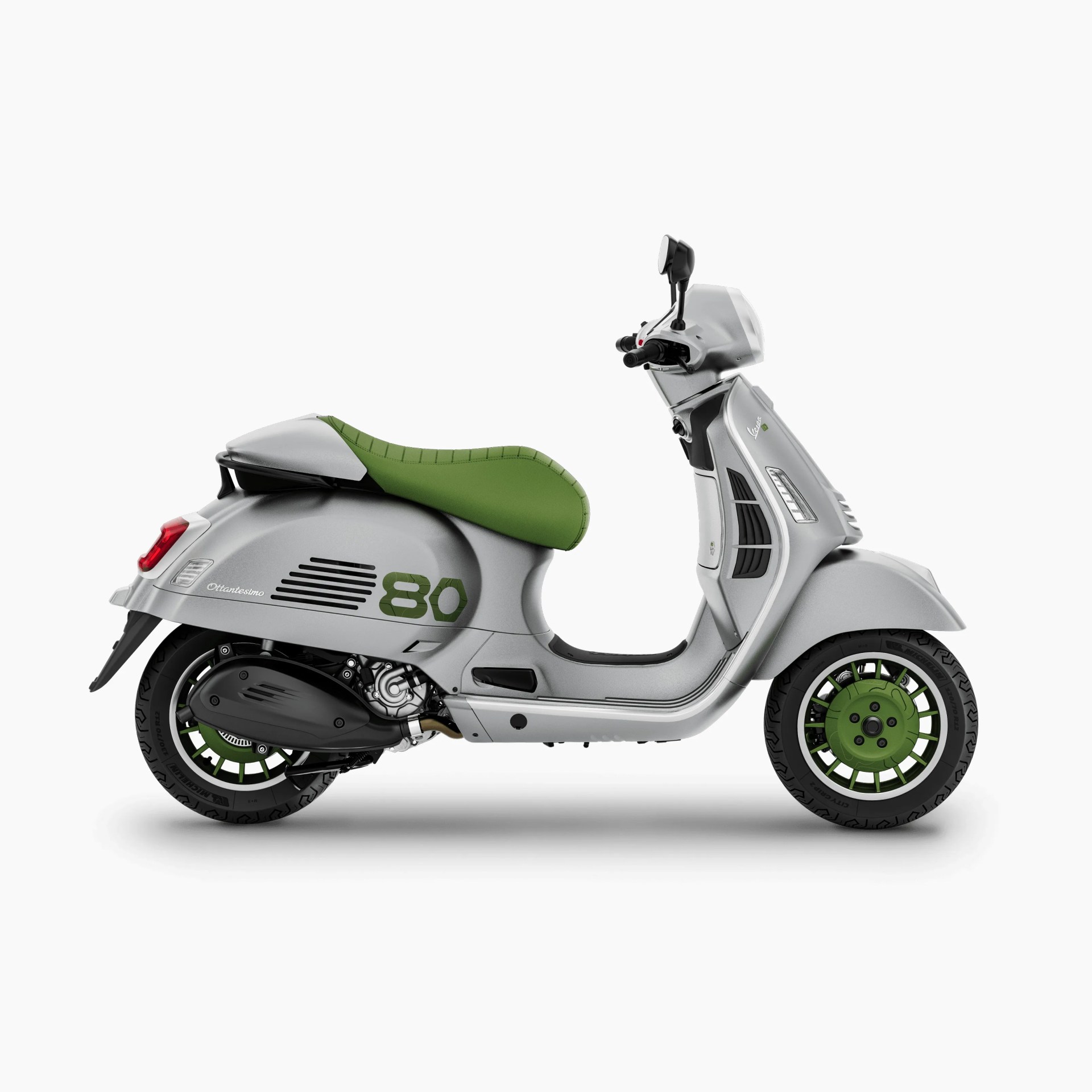 Silver Vespa scooter with green seat and green wheel rims on a white background.