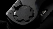 Close-up of a black mechanical dial with a star-shaped knob and textured grip.