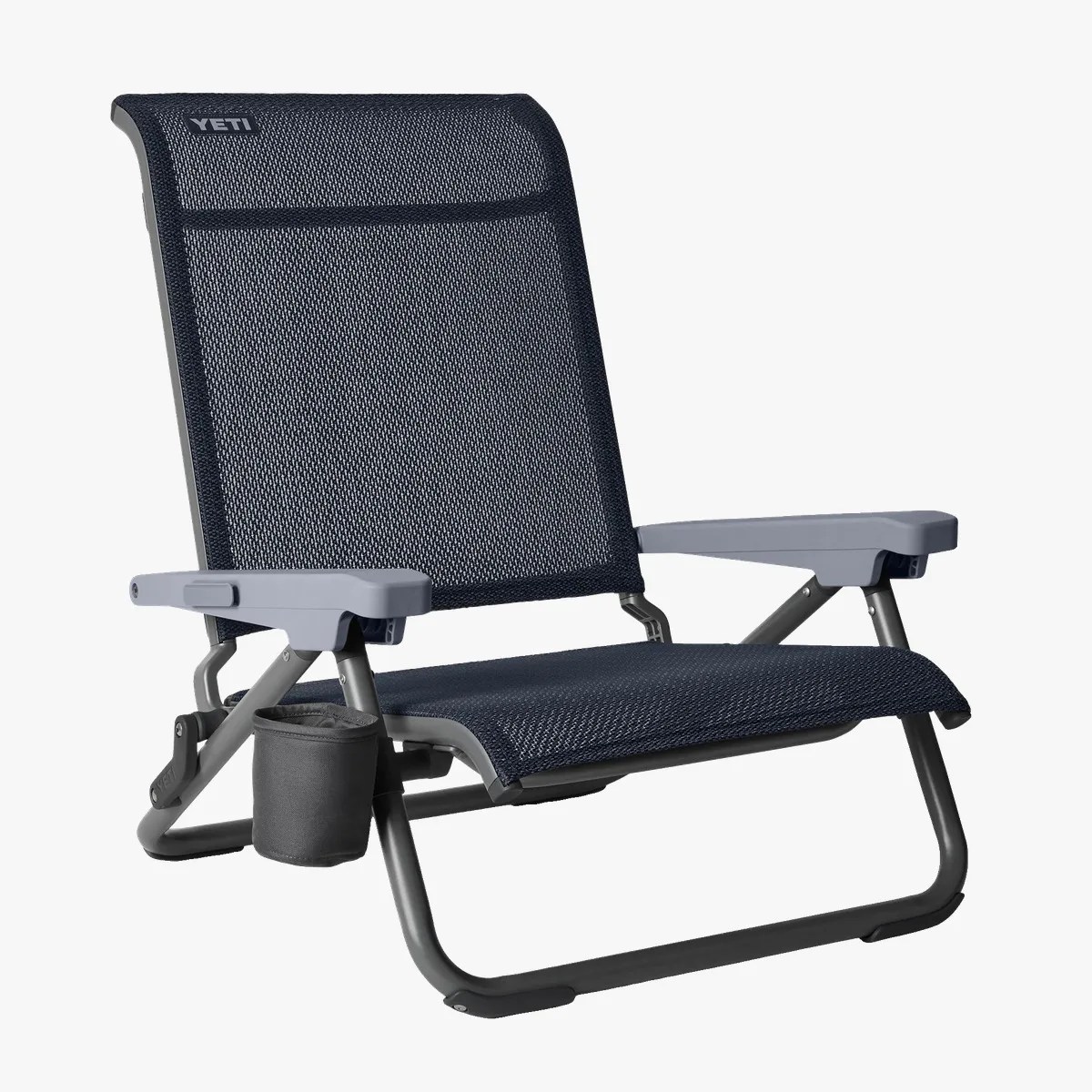 Low-profile navy mesh outdoor chair with gray armrests and a black cup holder attached to the frame.