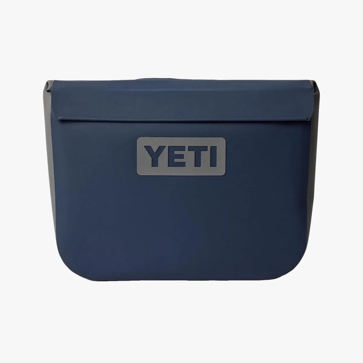 Navy blue YETI soft cooler bag with gray logo patch on front.