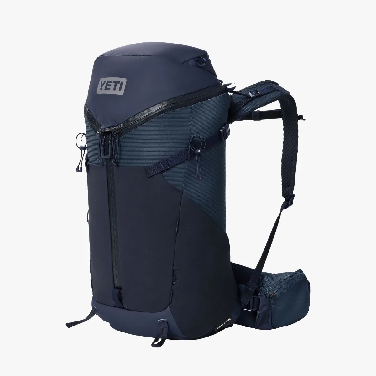 Navy blue YETI backpack with padded straps and zippered compartments.