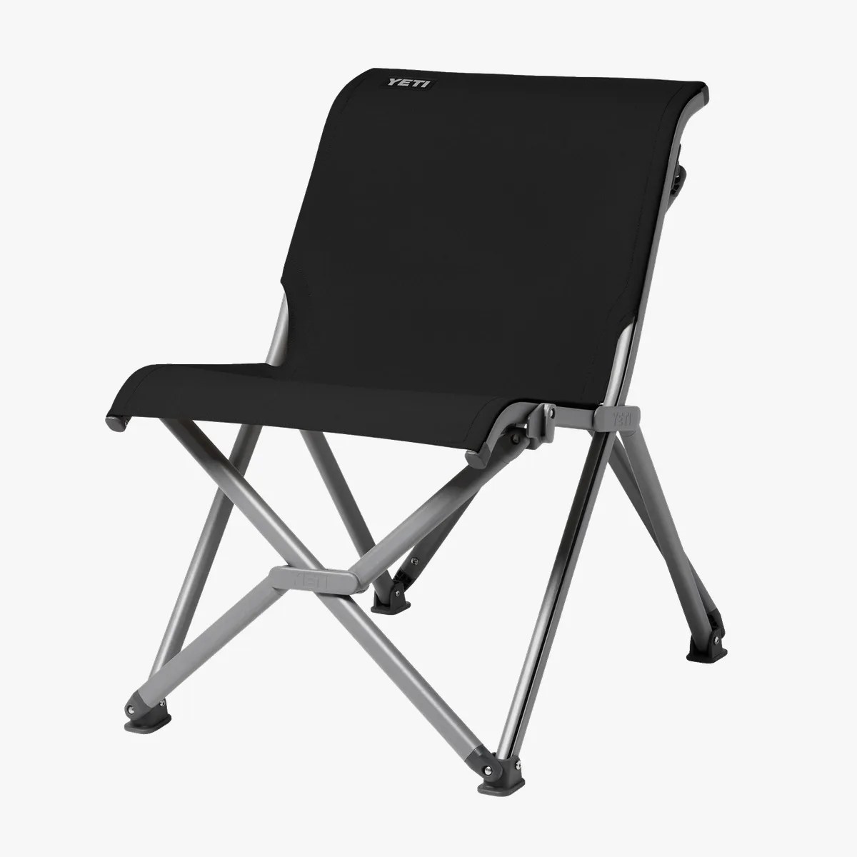 Black fabric folding chair with silver metal frame and YETI logo on the backrest.
