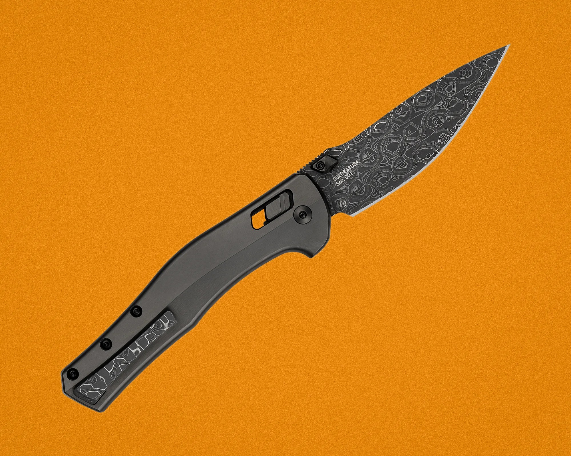 Black folding knife with patterned Damascus steel blade and matching inlay on handle against an orange background.