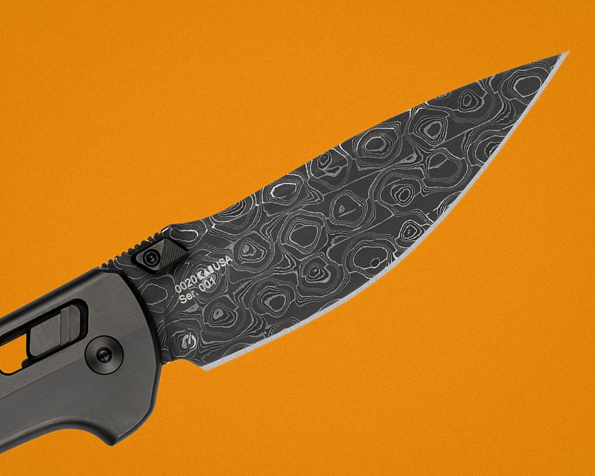 Black and gray patterned folding knife blade with gray handle on an orange background.