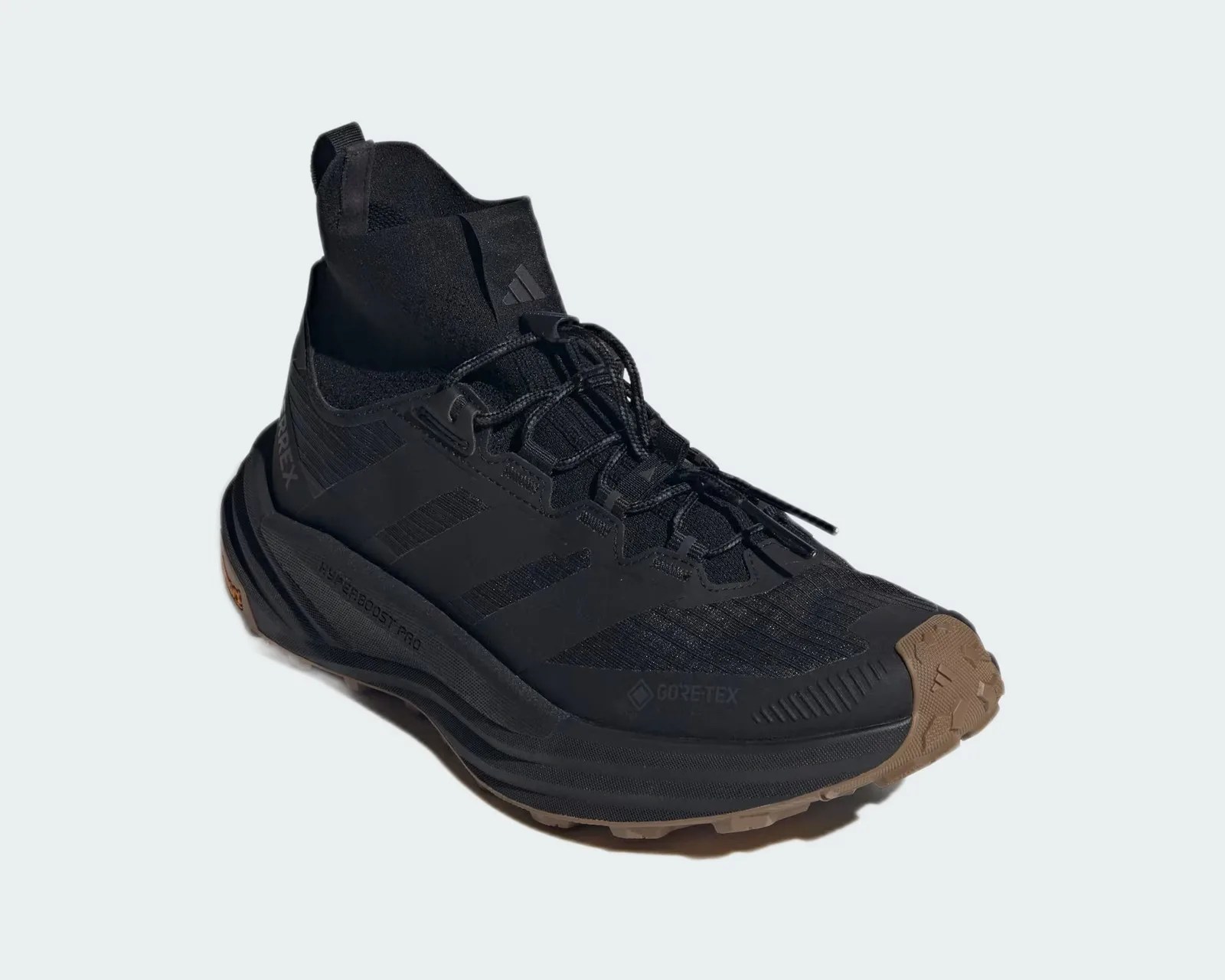 Black Adidas Gore-Tex hiking shoe with brown rubber sole and high ankle collar.