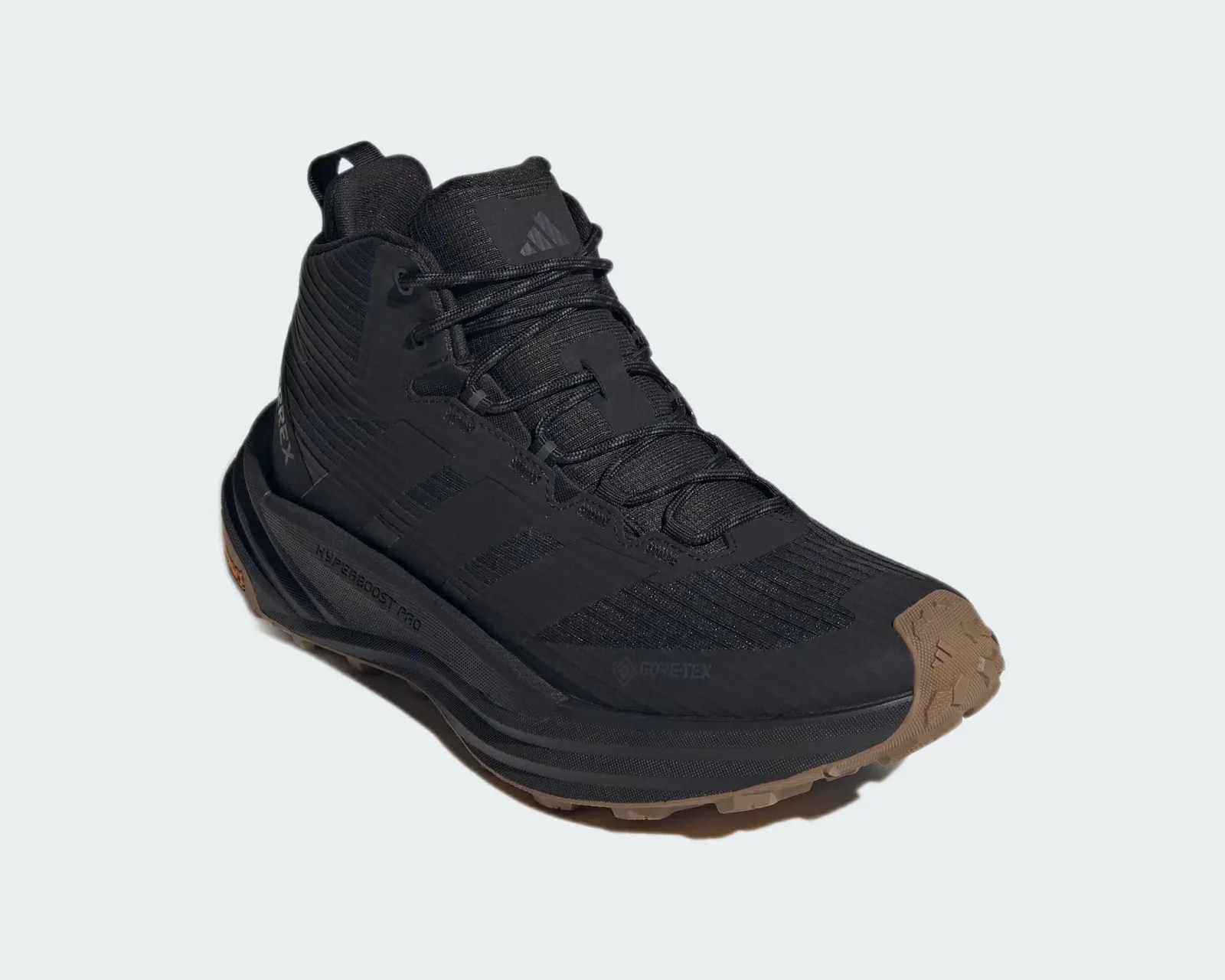 Black Adidas Terrex hiking shoe with brown textured sole and Gore-Tex branding.