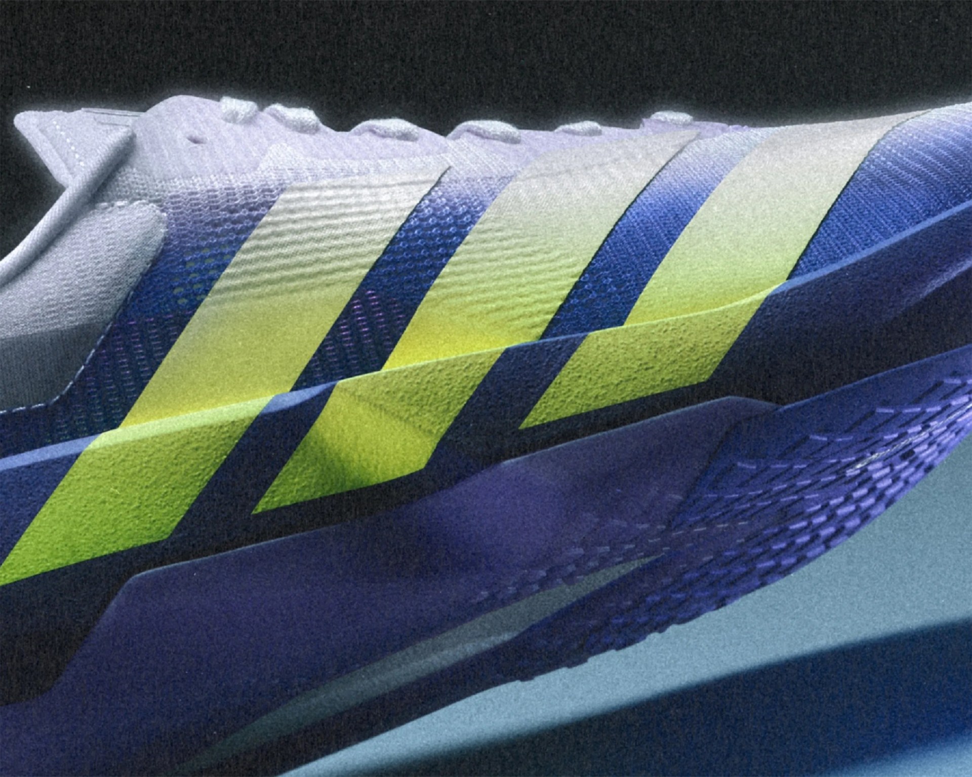 Close-up of a blue and yellow athletic shoe with textured fabric and three yellow stripes on the side.