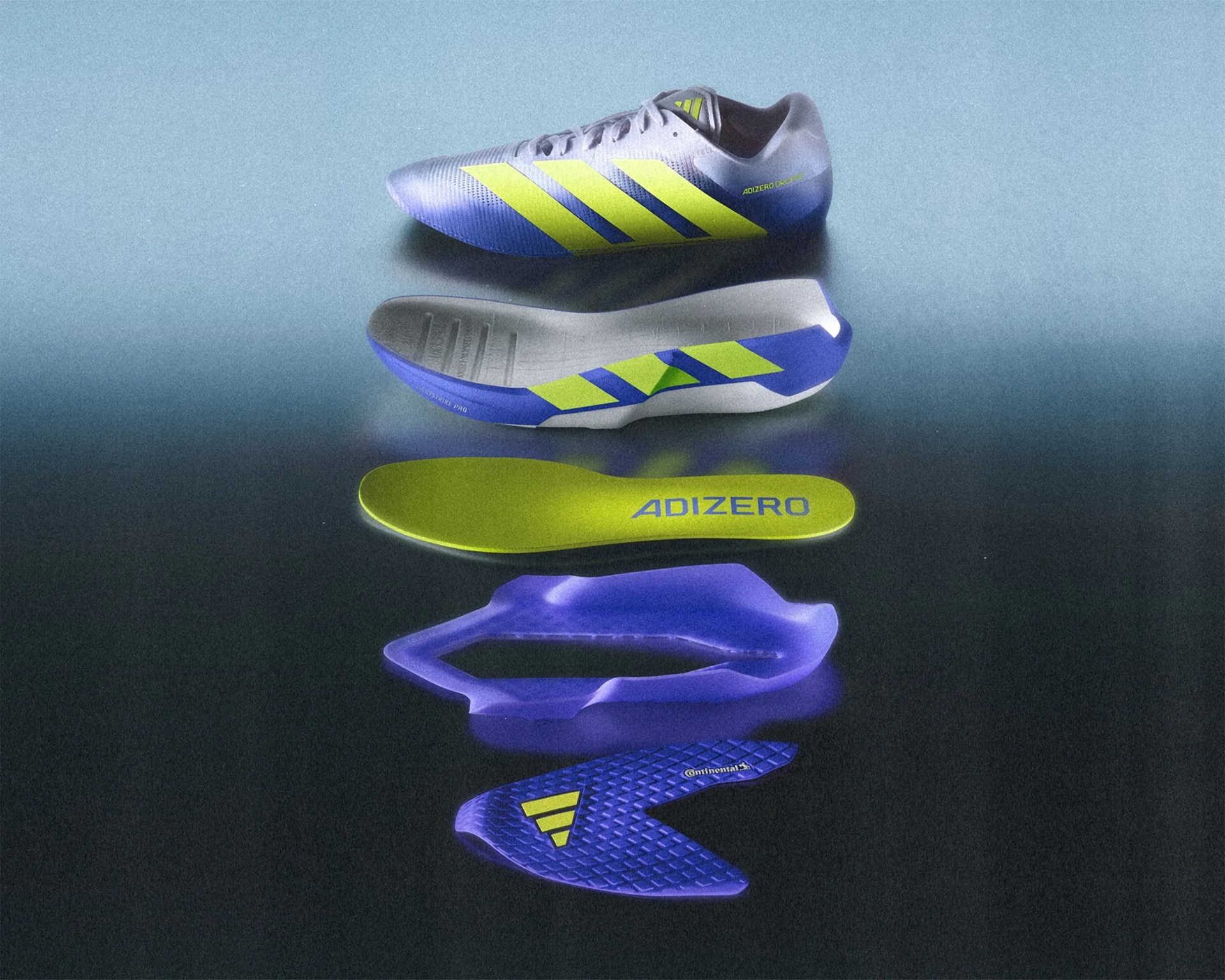 Disassembled blue and neon yellow Adidas Adizero running shoe showing upper, midsole, insole, and outsole layers.