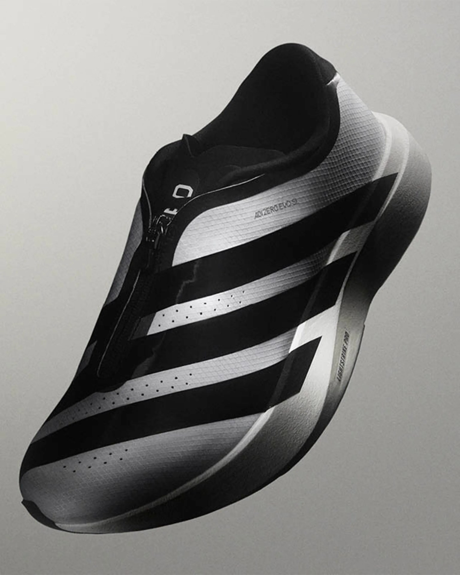 Black and white Adidas Adizero SL running shoe with a zipper closure and lightweight midsole.
