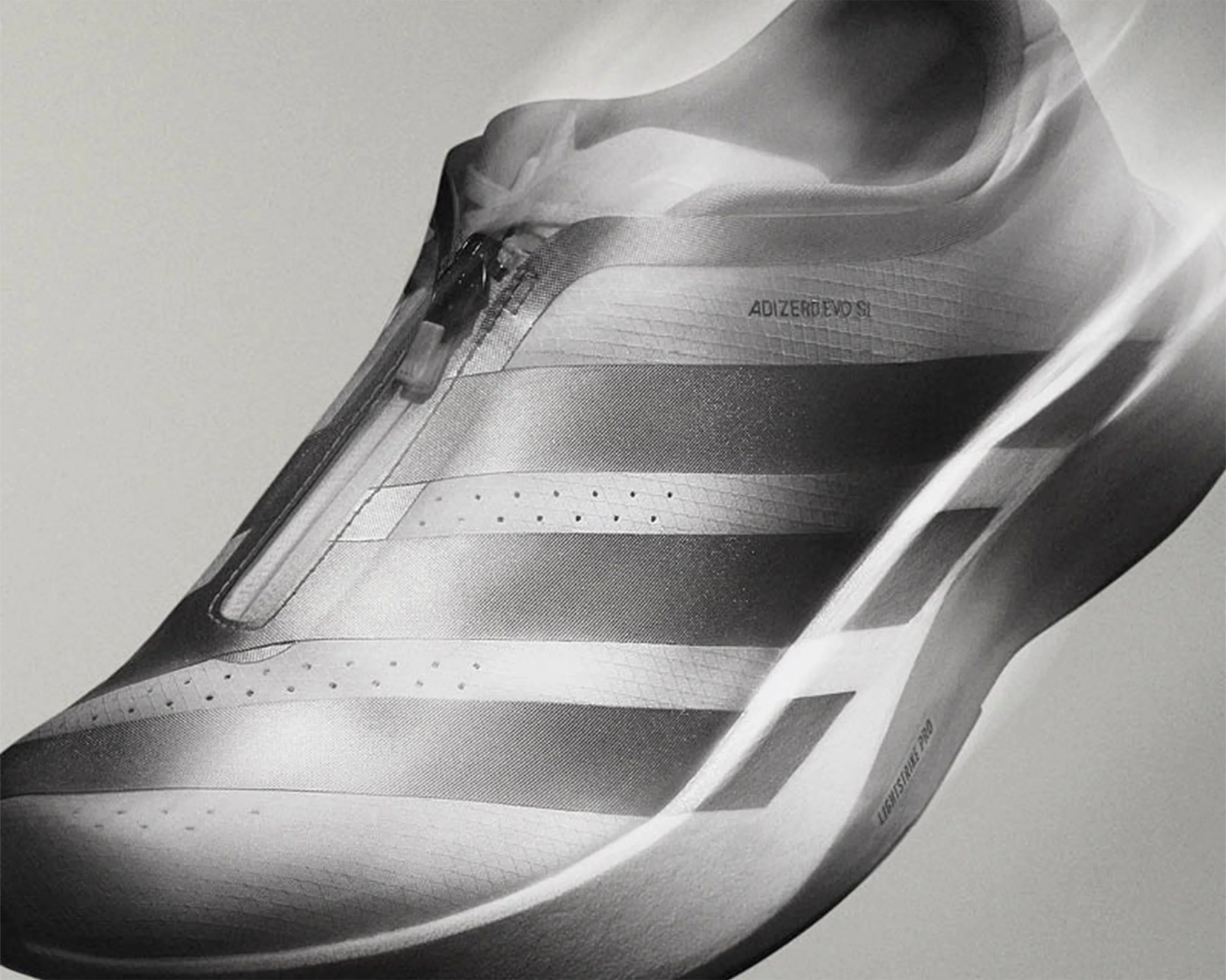 Close-up of a sleek Adidas Adizero running shoe with a zipper closure and aerodynamic design.