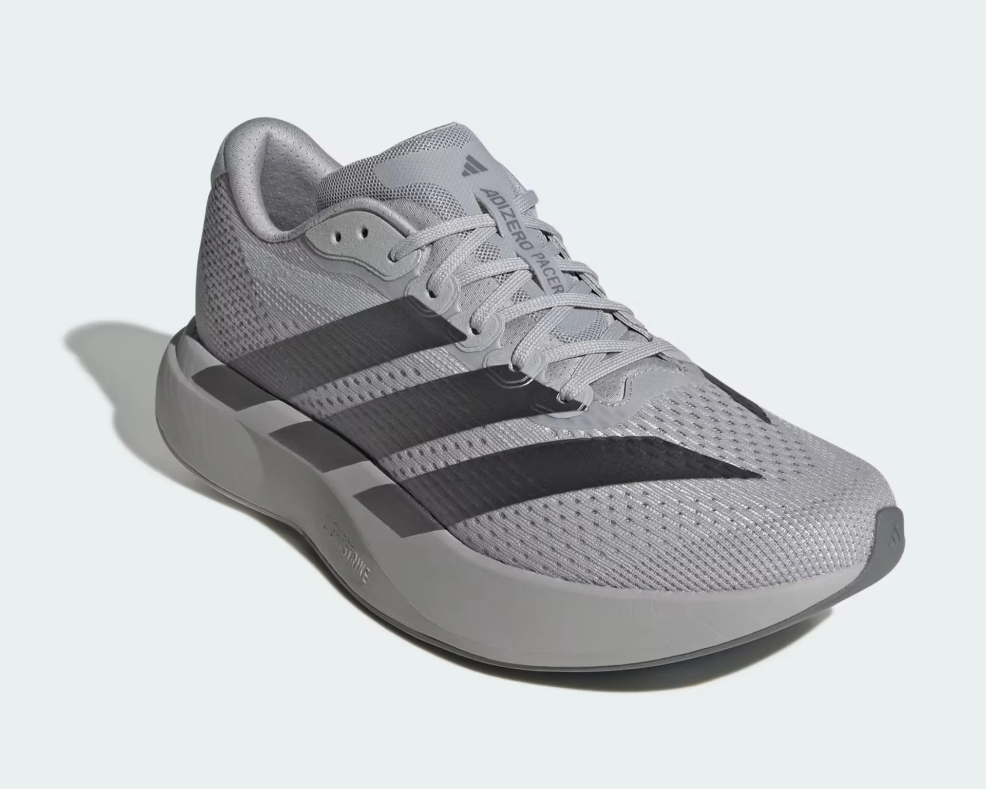 Light gray Adidas Adizero running shoe with black stripes and cushioned sole.
