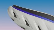 Close-up of a white sneaker sole with black accents and a purple stripe near the black midsole.
