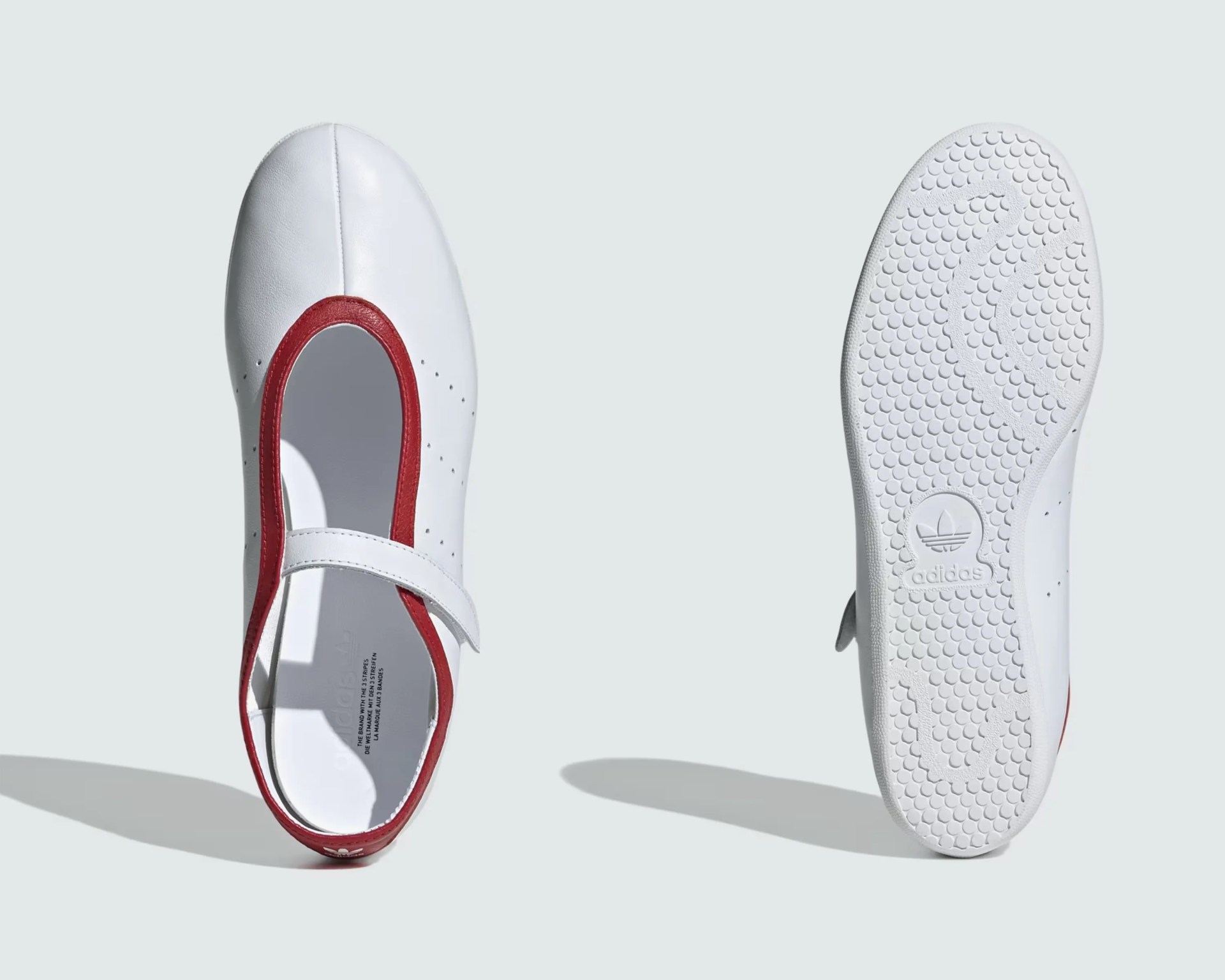 White Adidas Mary Jane shoe with red trim and textured sole showing Adidas logo.