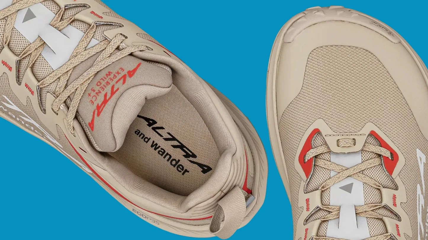 Pair of beige Altra running shoes with red accents and mesh fabric uppers on a blue background.