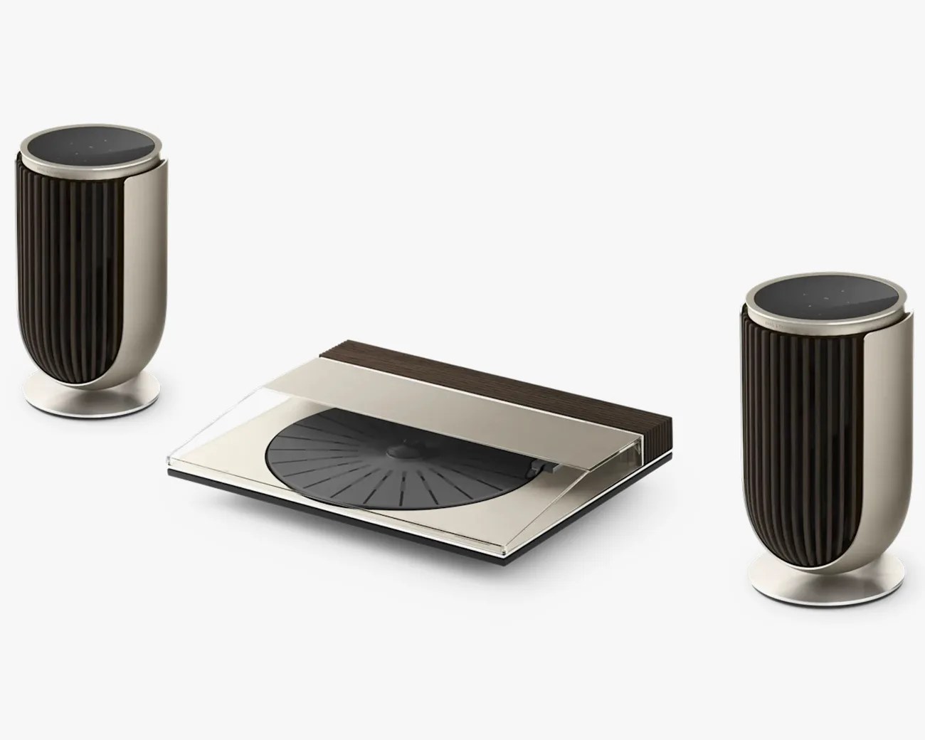 Modern turntable with transparent cover and two cylindrical speakers with ribbed black fronts and metallic bases.