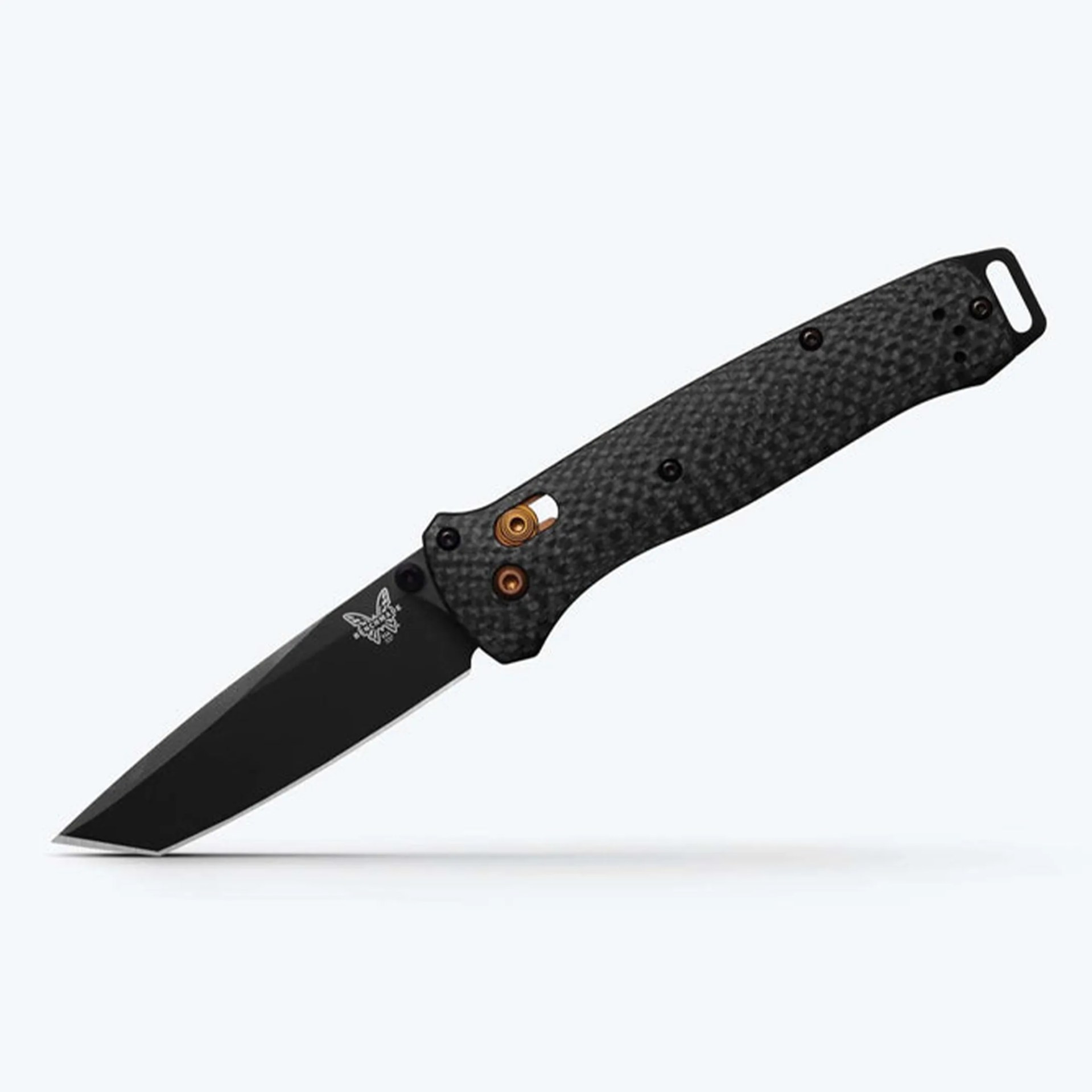 Black folding knife with textured carbon fiber handle and partially visible butterfly logo on the blade.