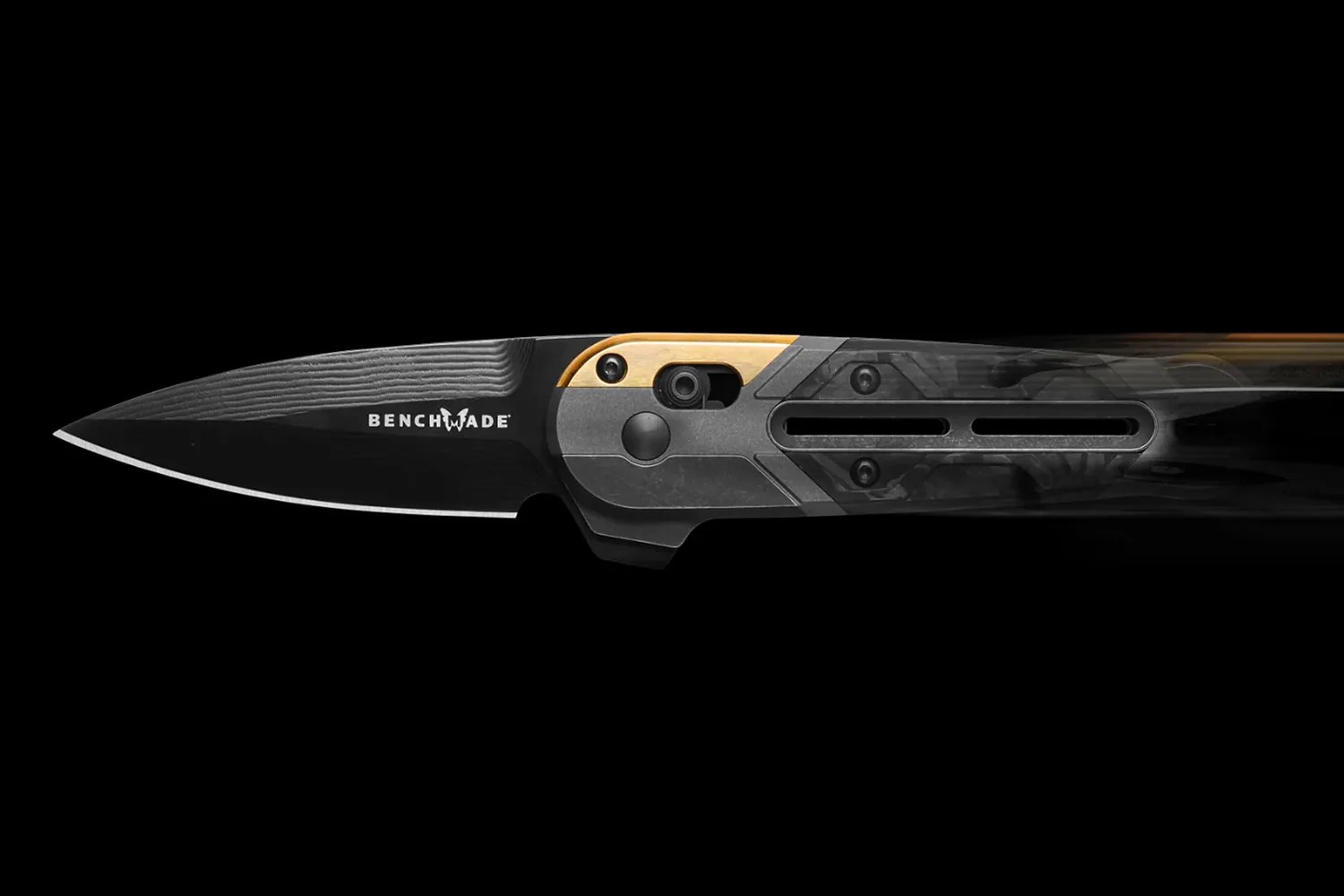 Black Benchmade folding knife with a textured blade and carbon fiber handle with gold accent.